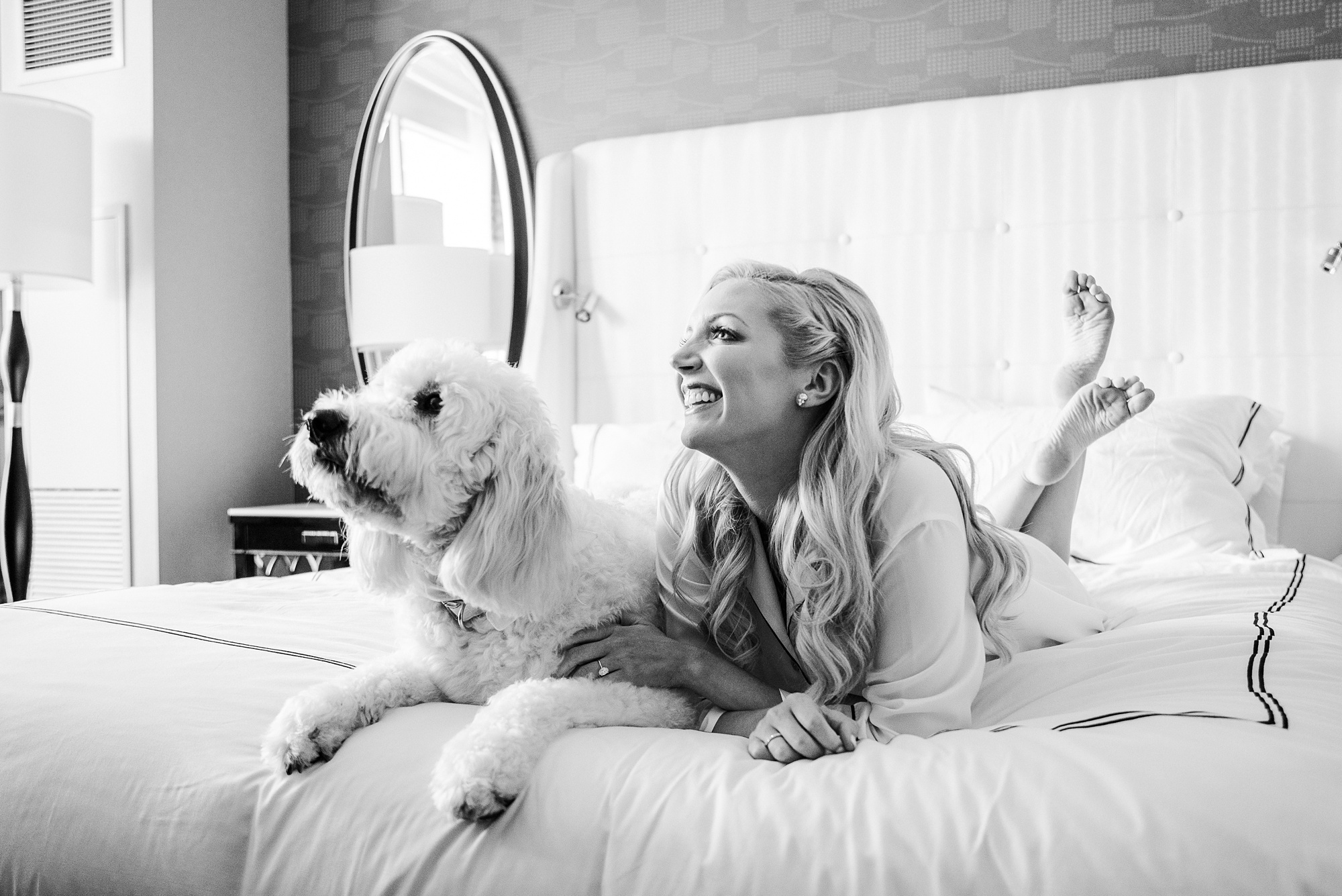 bride and dog lay on bed before Byron's South End wedding