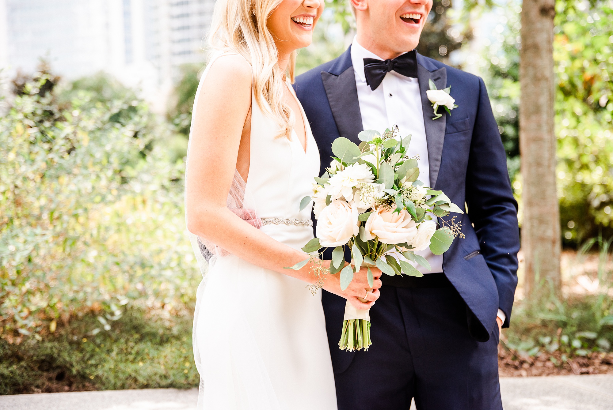 bride and groom laugh during wedding photos at Romare Bearden Park