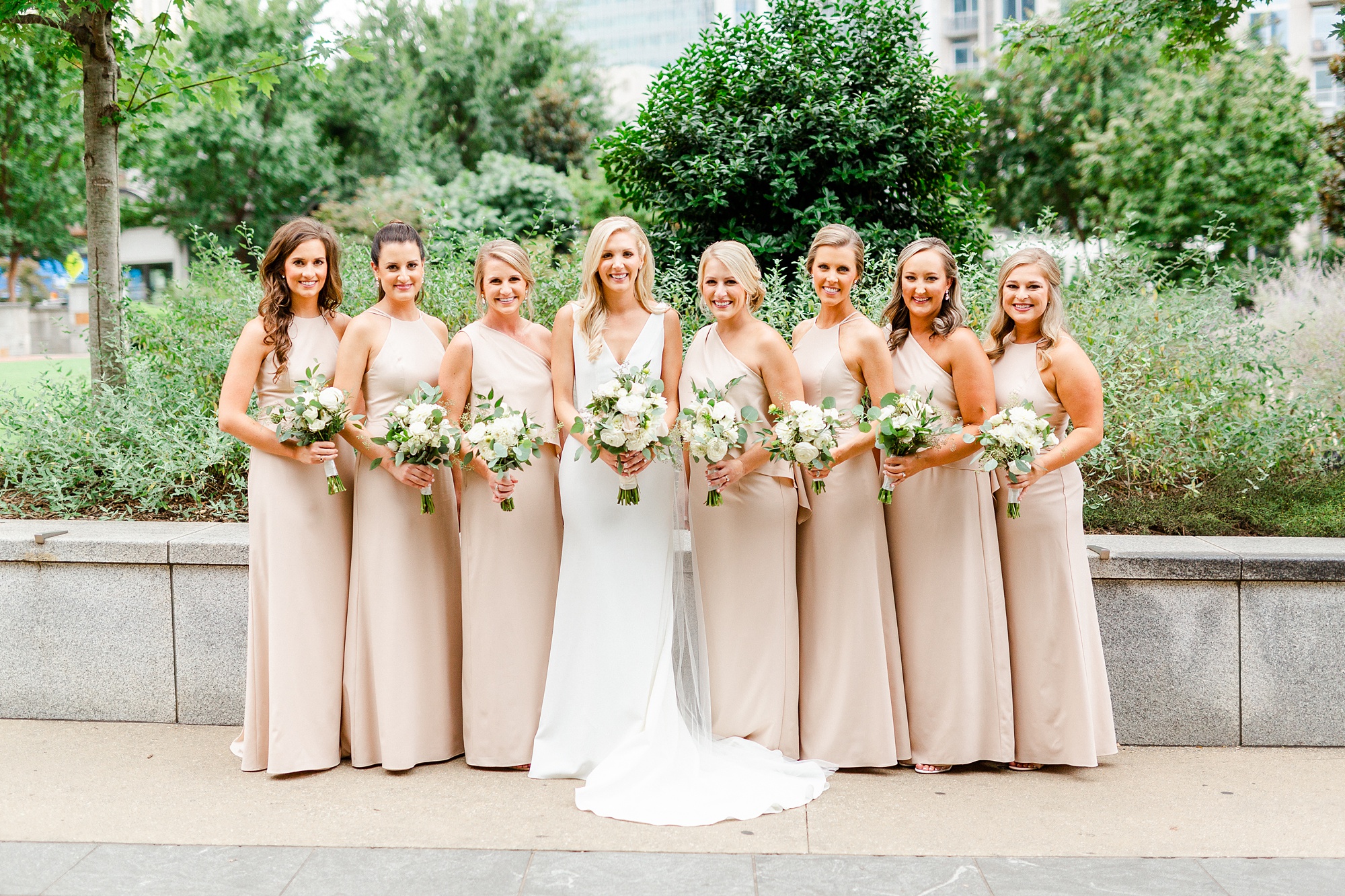bride poses with bridesmaids at Romare Bearden Park
