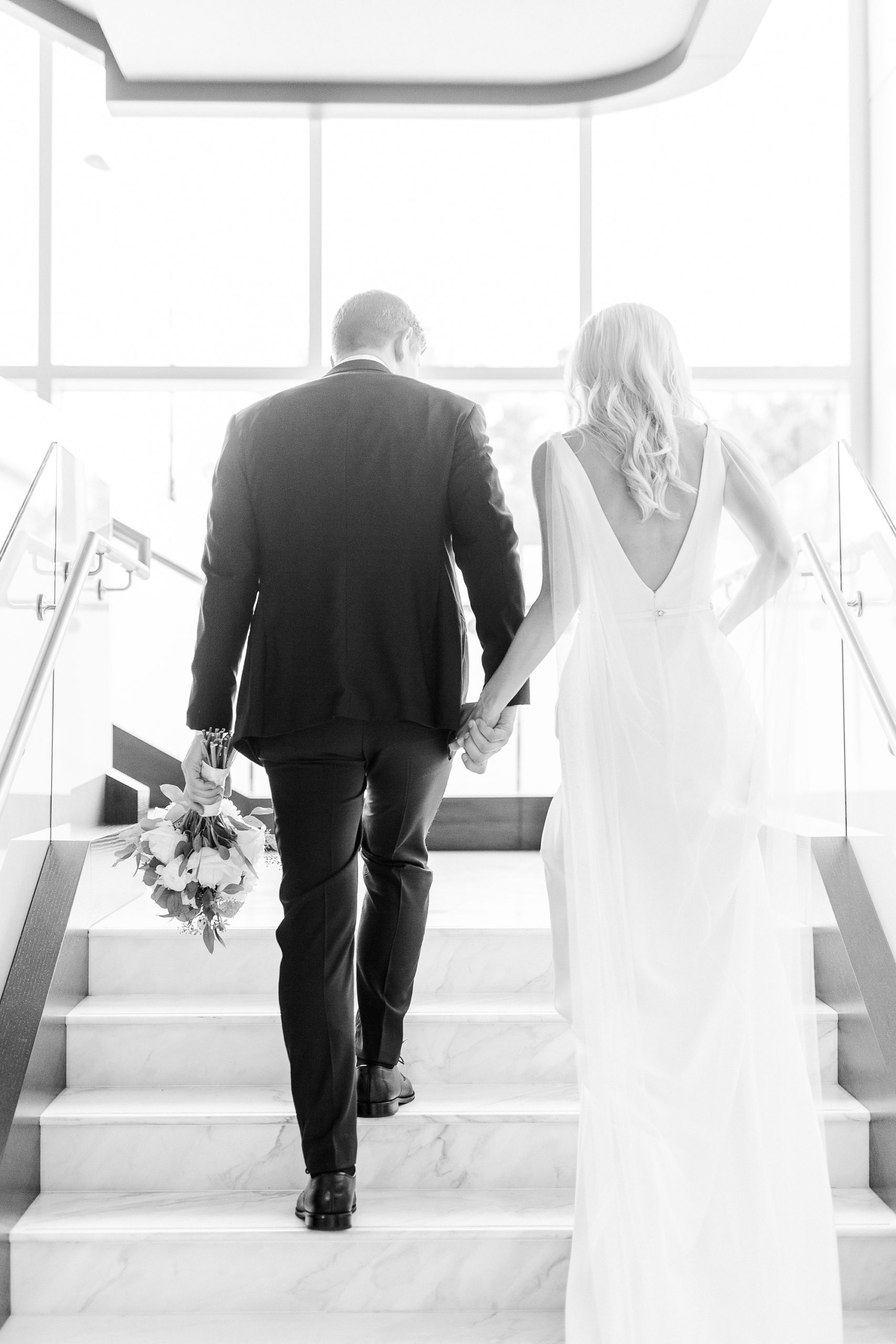 bride and groom walk up steps at Kimpton Hotel