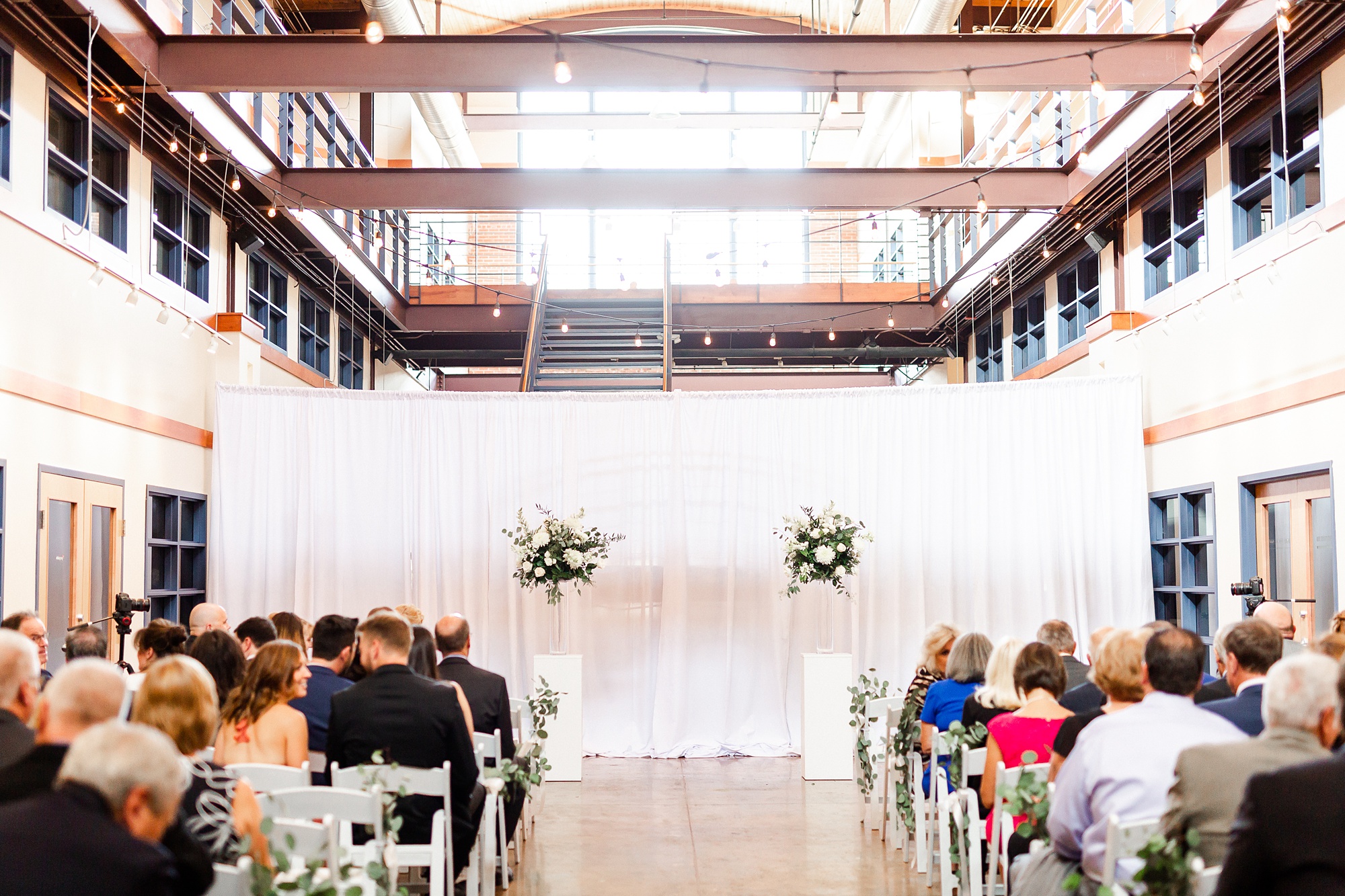 Design Center Atrium wedding ceremony with floral centerpieces