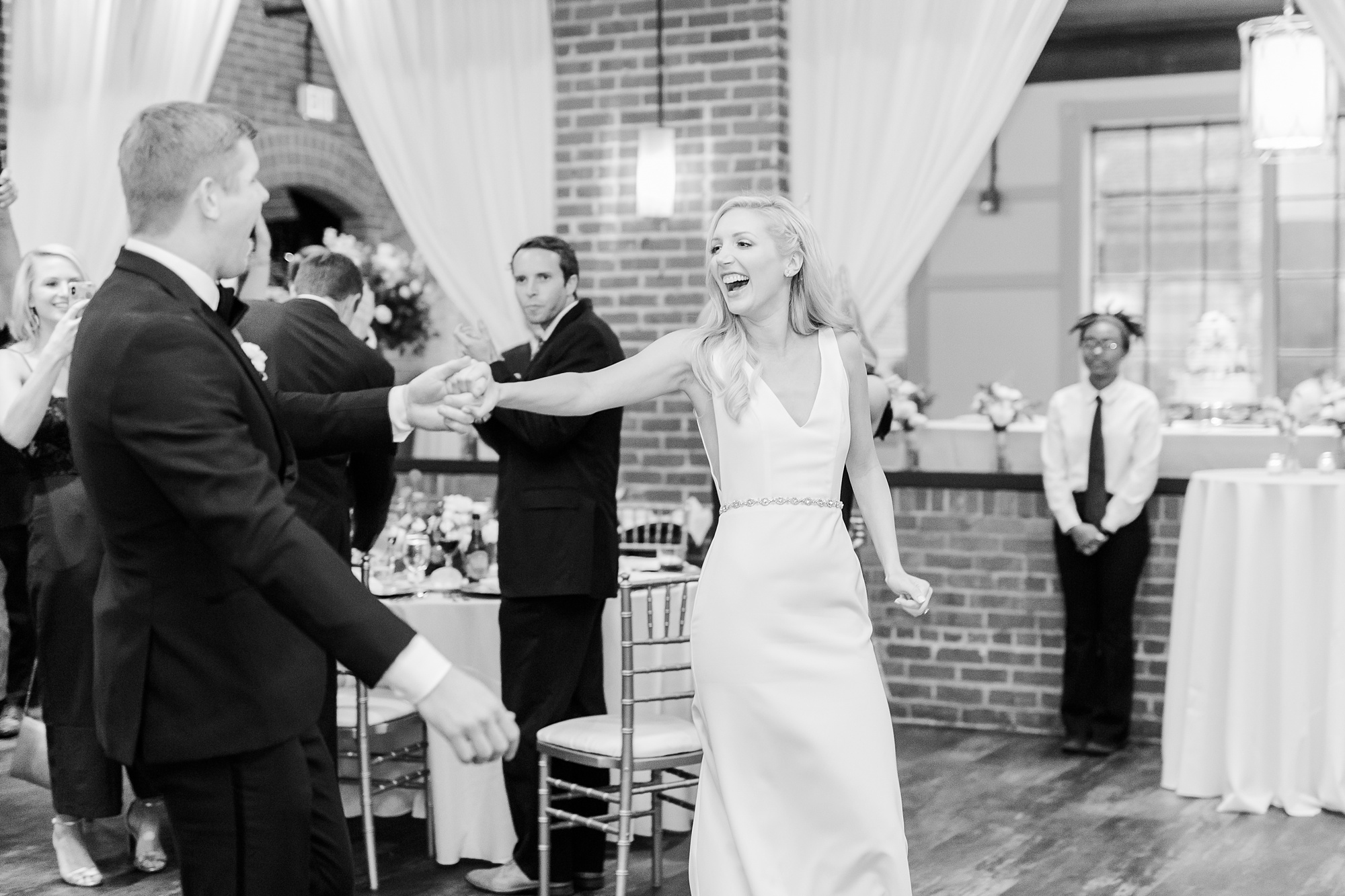 bride laughs during entrance to Byron's South End reception