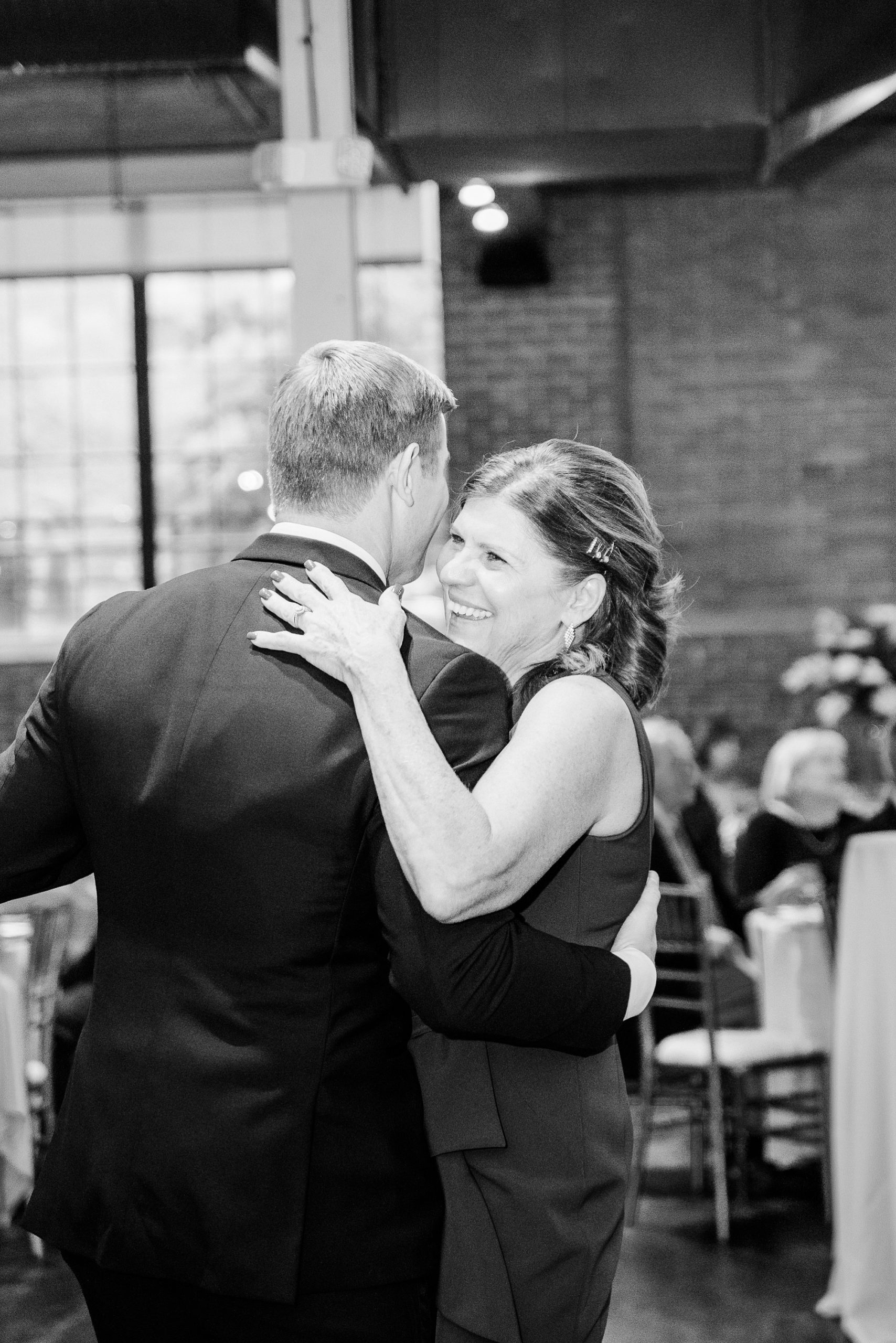 groom dances with mother during Byron's South End wedding reception