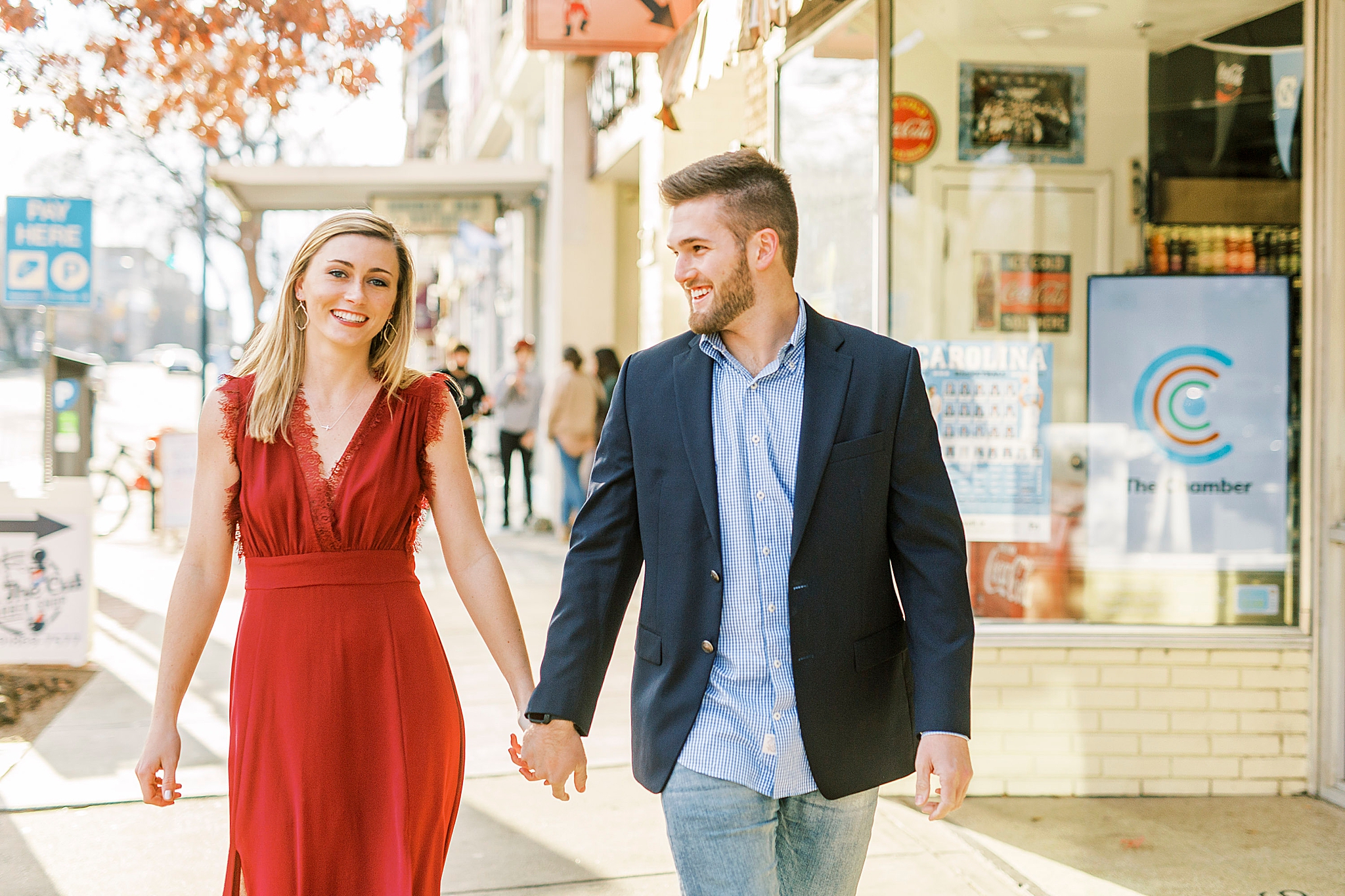 engaged couple walks down street in downtown Chapel Hill engagement session