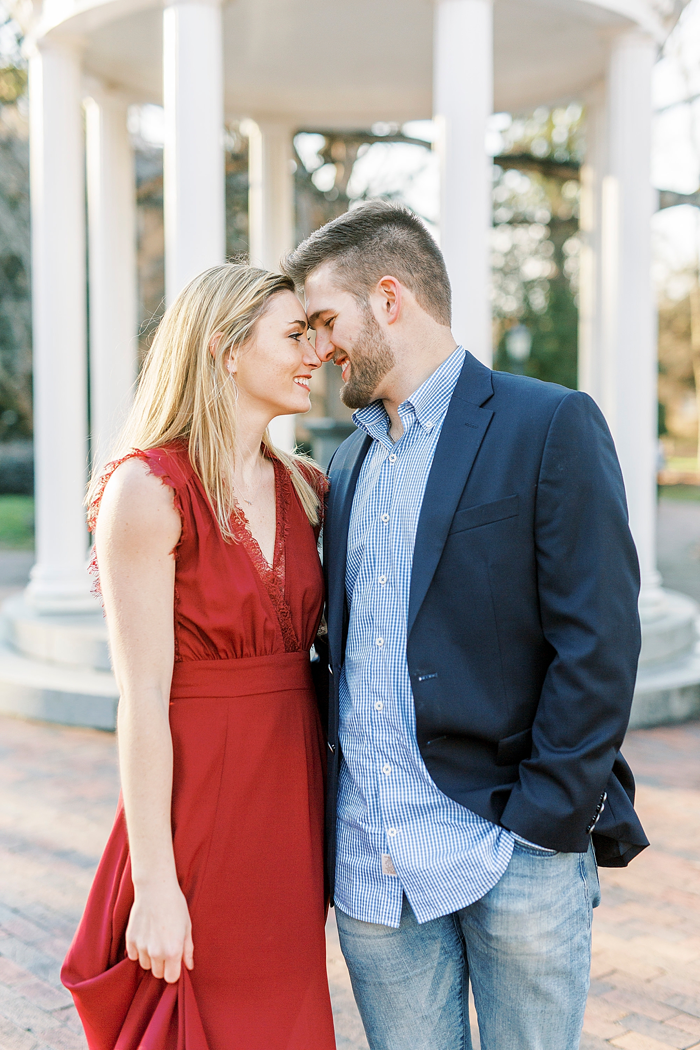 bride and groom stand with noses touching laughing during NC engagement photos