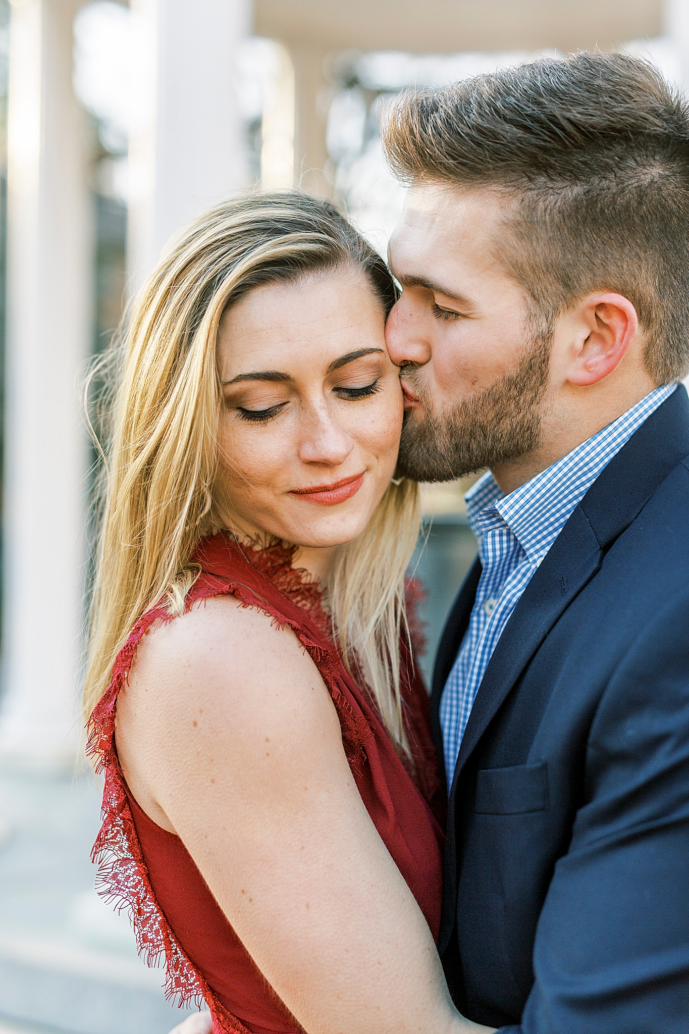 groom kisses bride's cheek during Chapel Hill engagement session