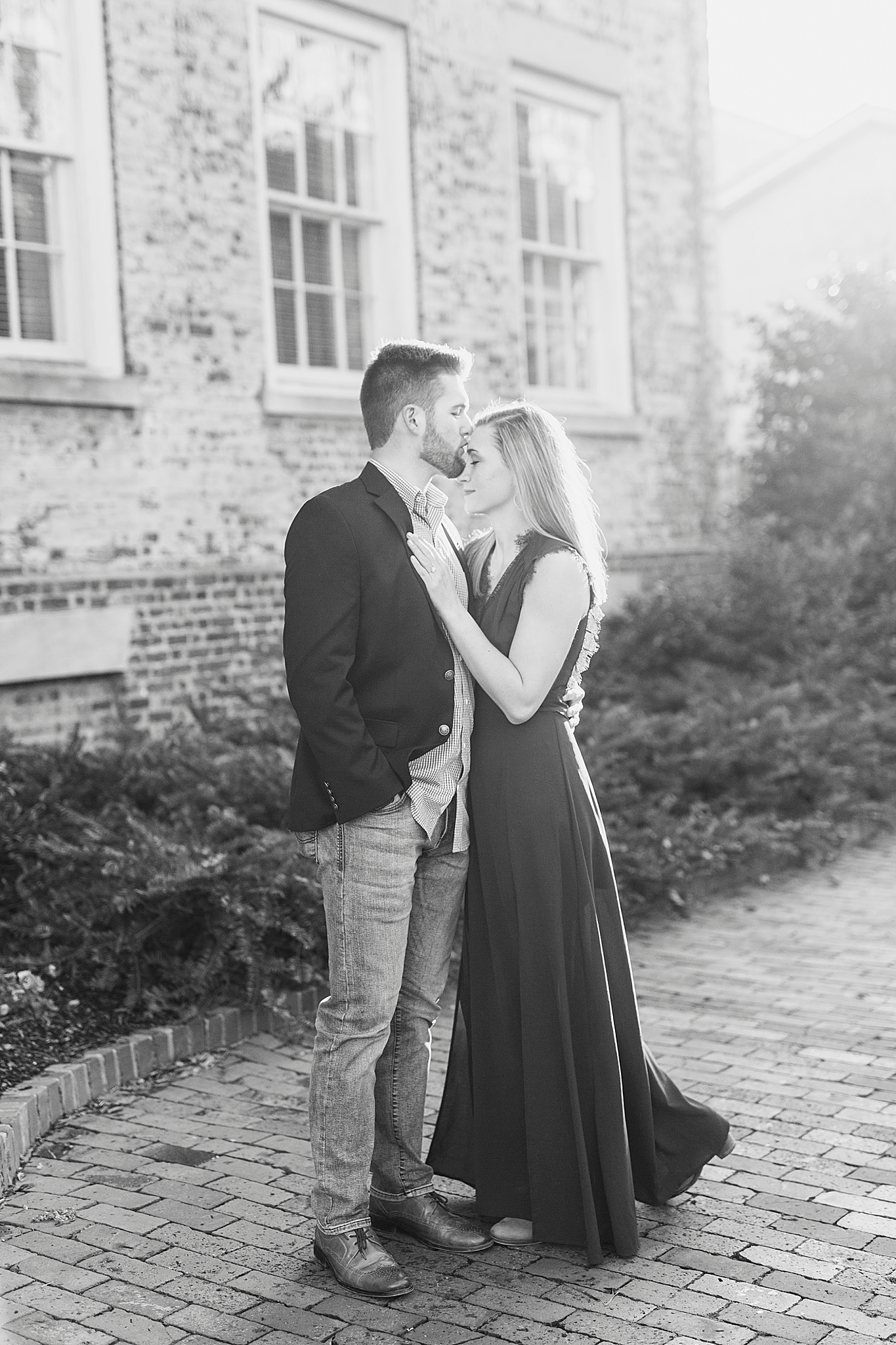 groom kisses fiancees forehead during Chapel Hill engagement session