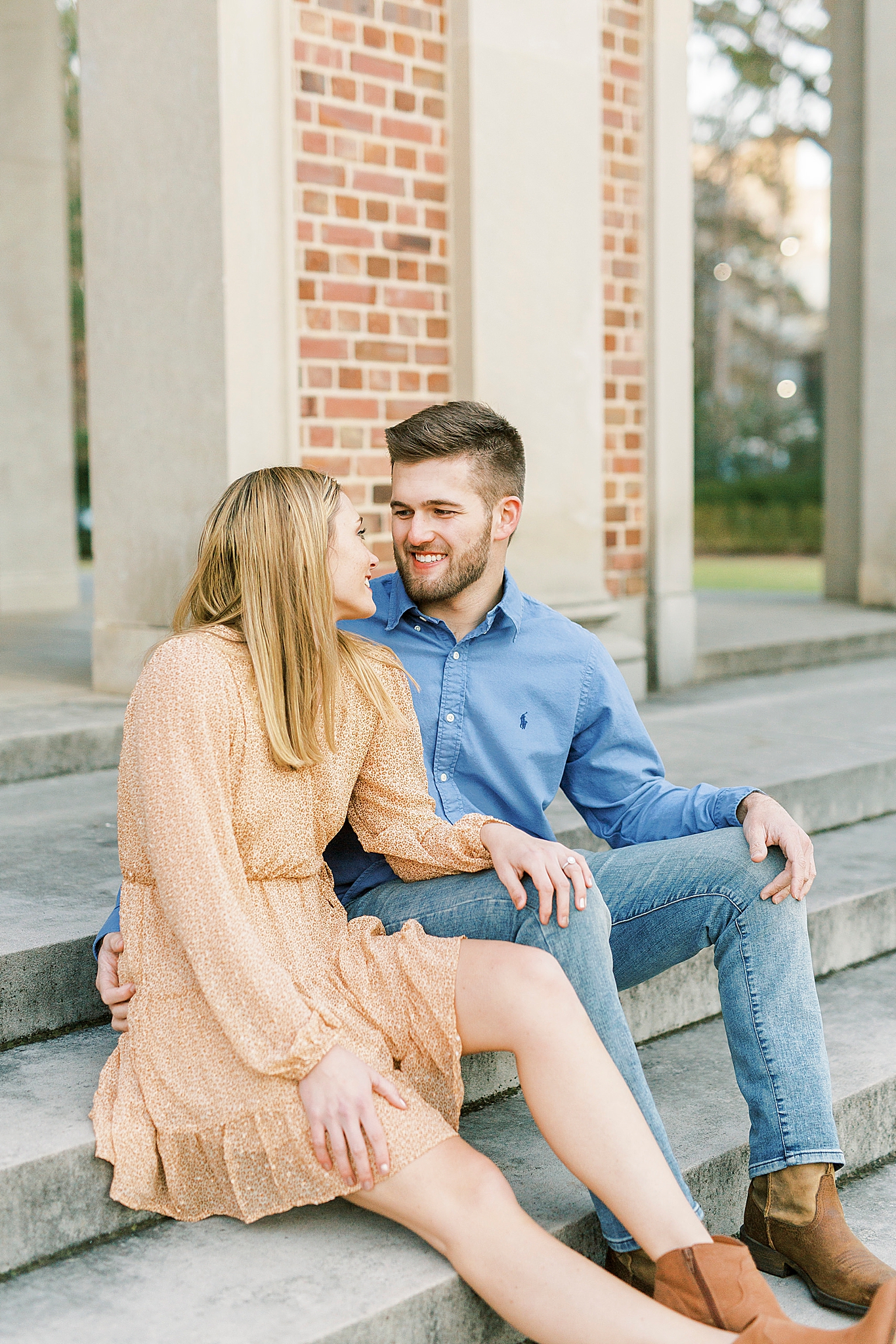 UNC alumni sit on steps of bell tower during engagement photos