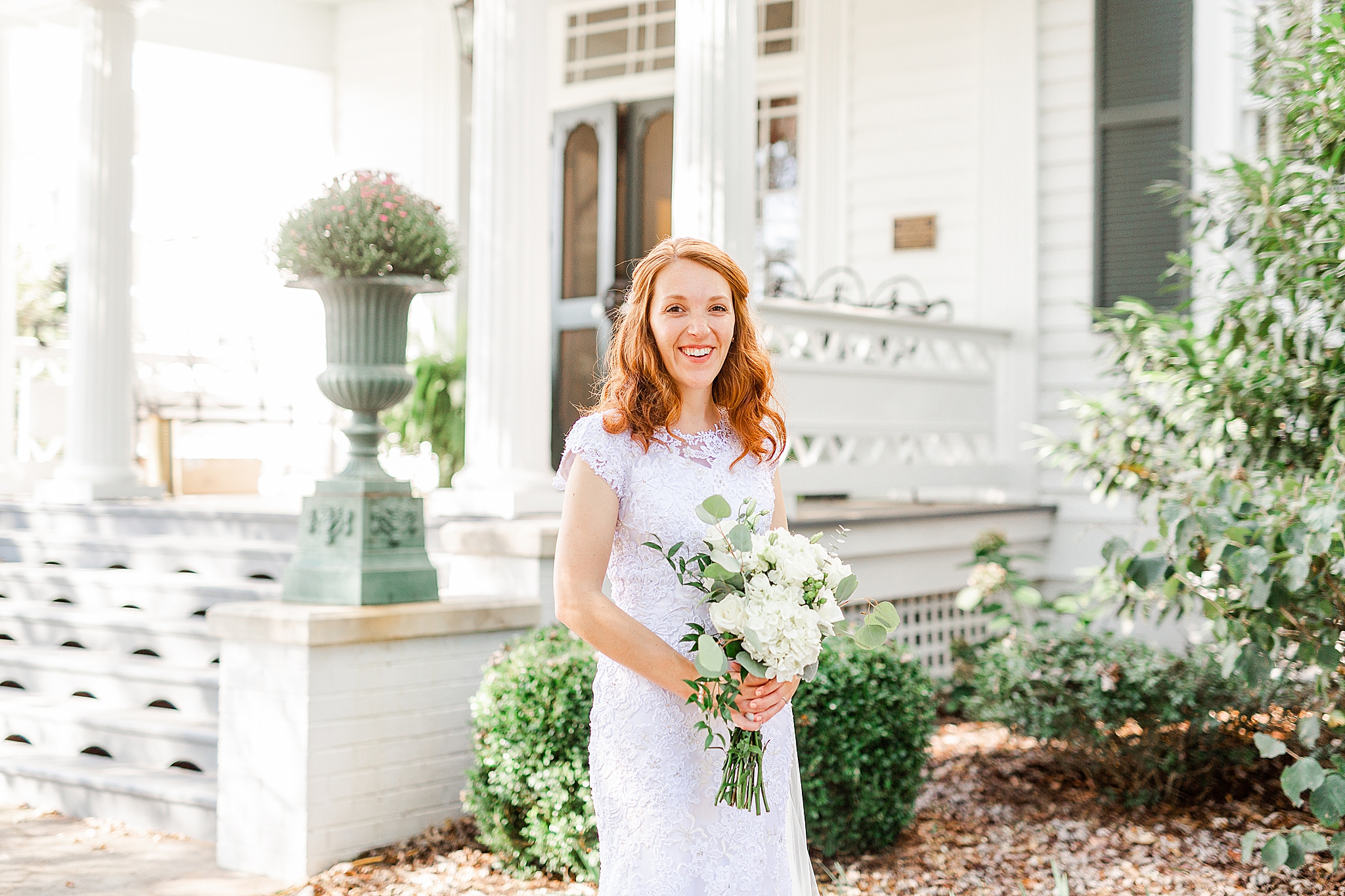 bride holds bouquet in front of southern house in North Carolina