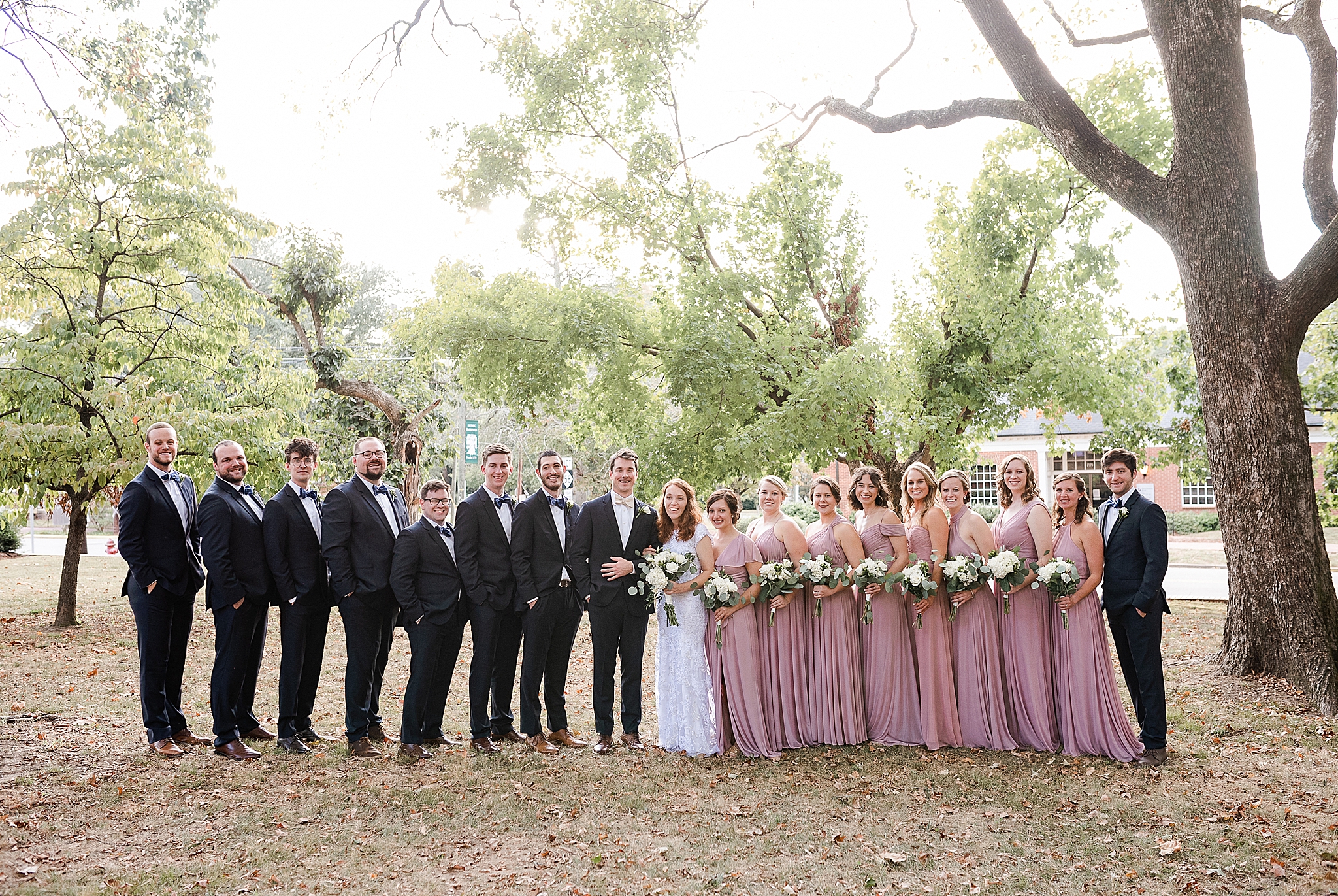 bride and groom pose with bridal party