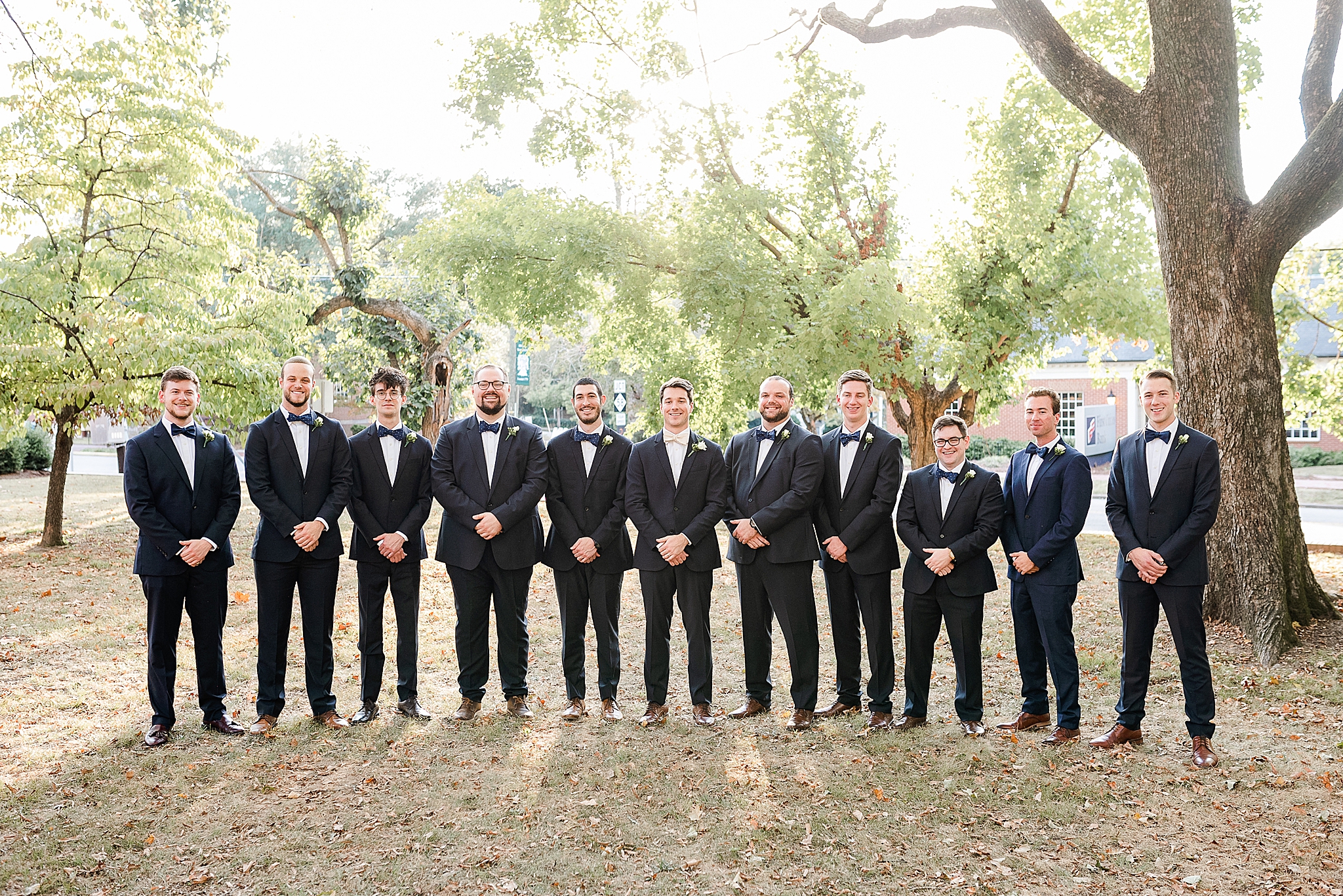 groomsmen in navy suits before classic Southern wedding
