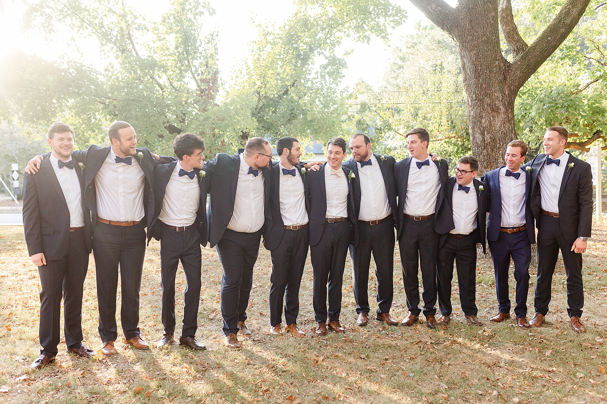 groomsmen hug each other during classic Southern wedding