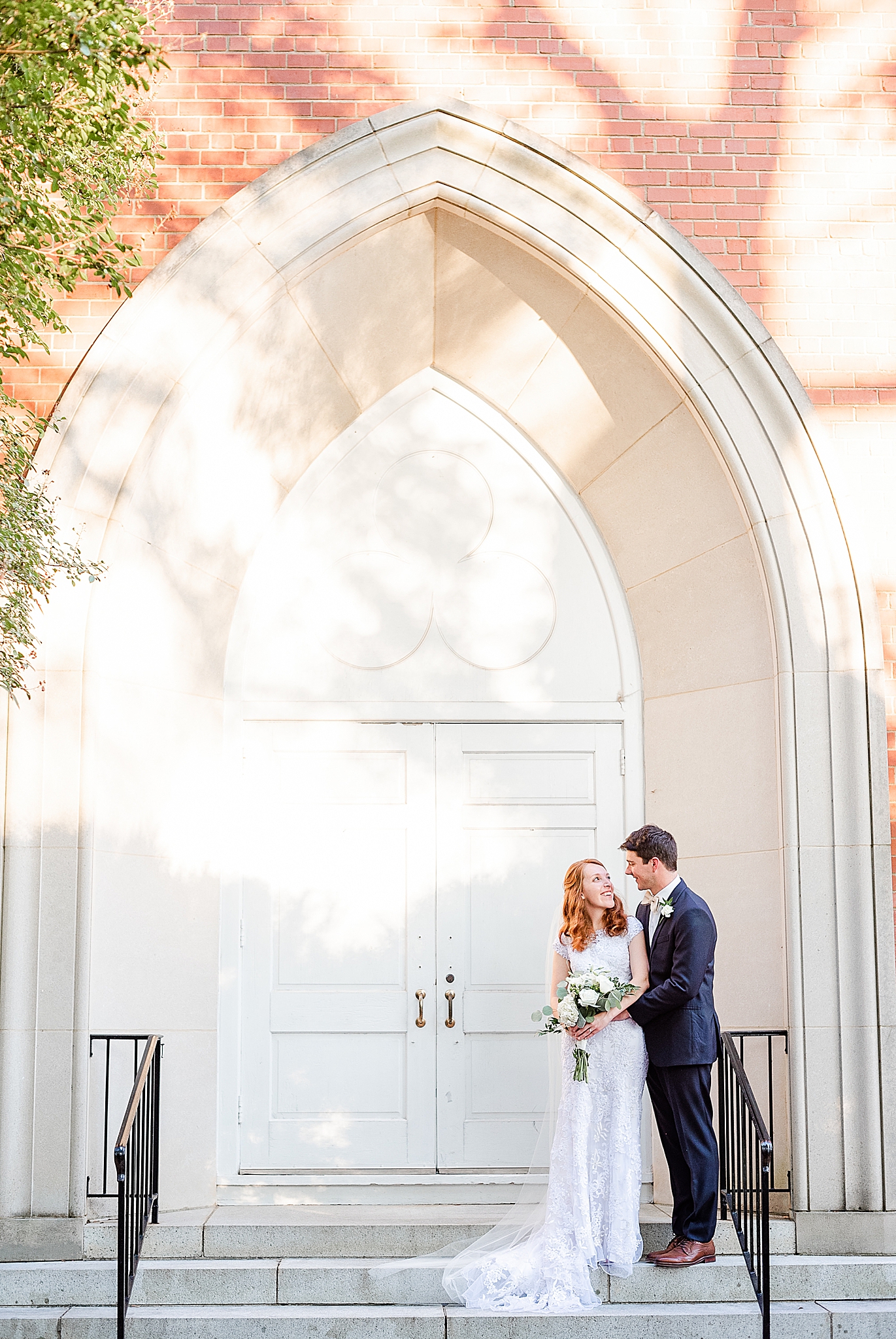 classic Southern wedding portraits on church steps by archway
