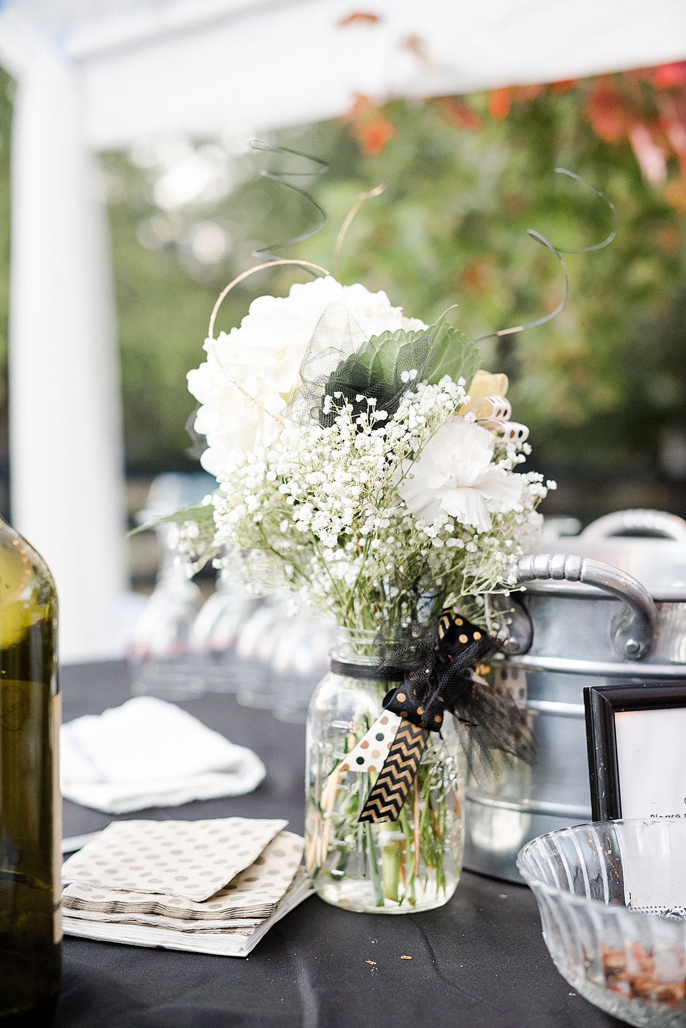 centerpieces with black ribbon and baby's breath