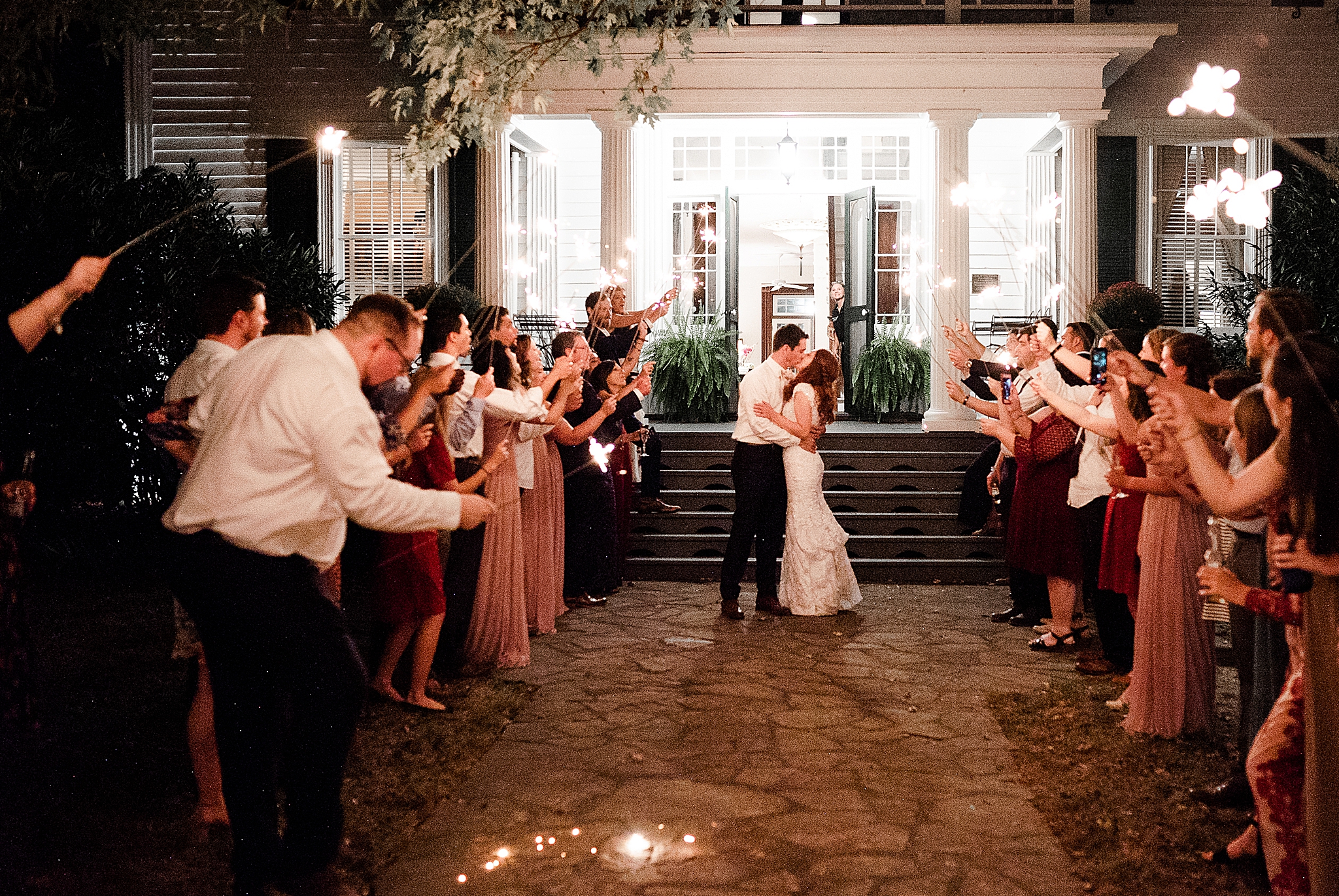 newlyweds kiss during sparkler exit at Lake O' The Woods Plantation wedding reception
