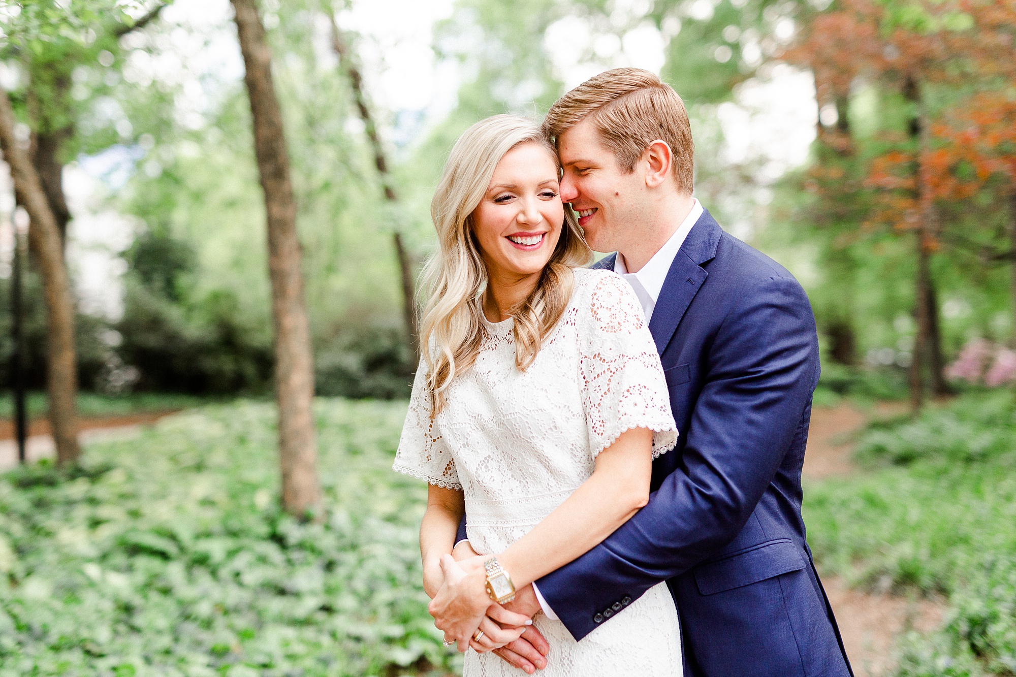 groom whispers to bride during engagement photos