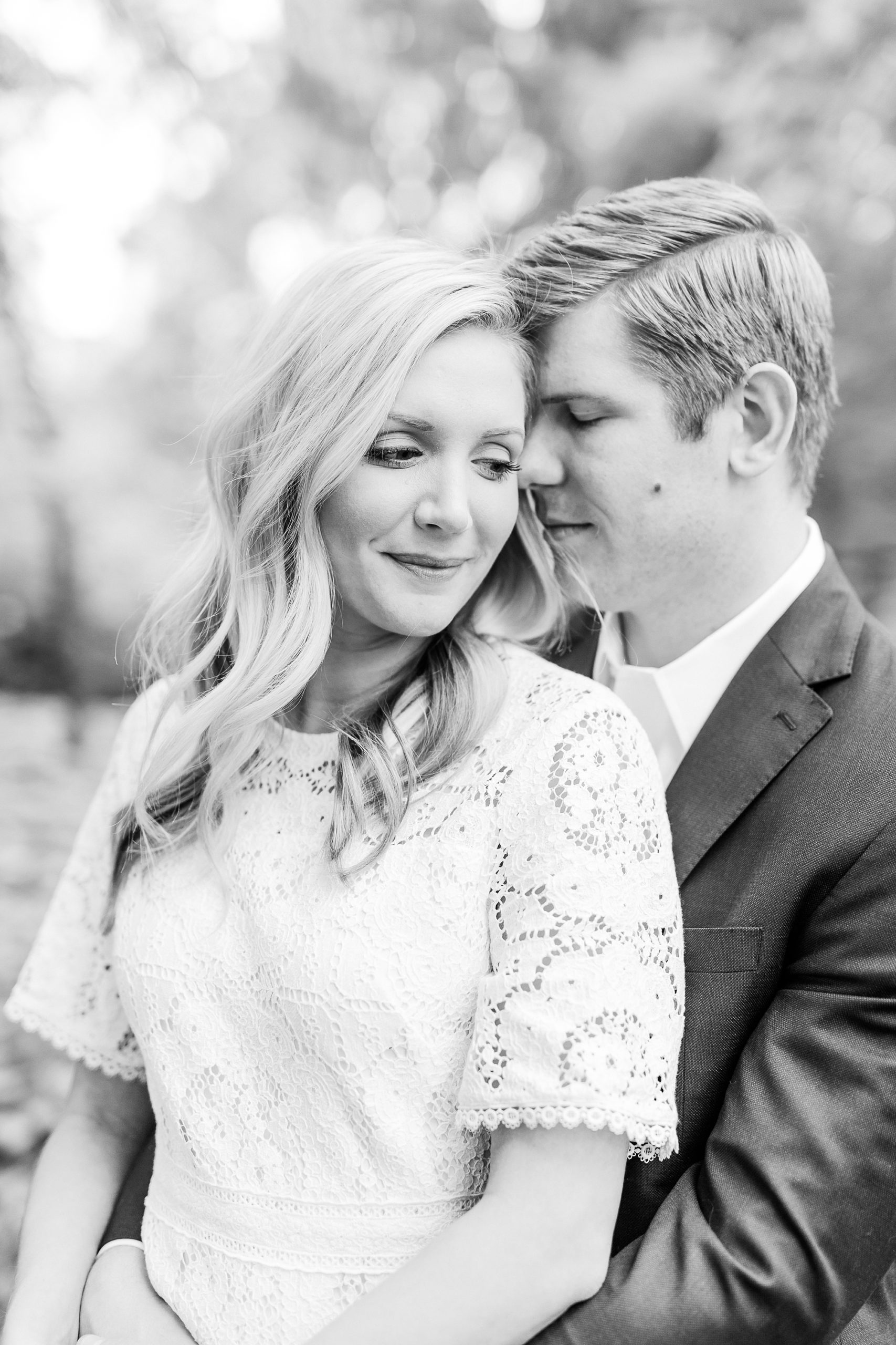 bride and groom cuddle during stylish Charlotte engagement photos