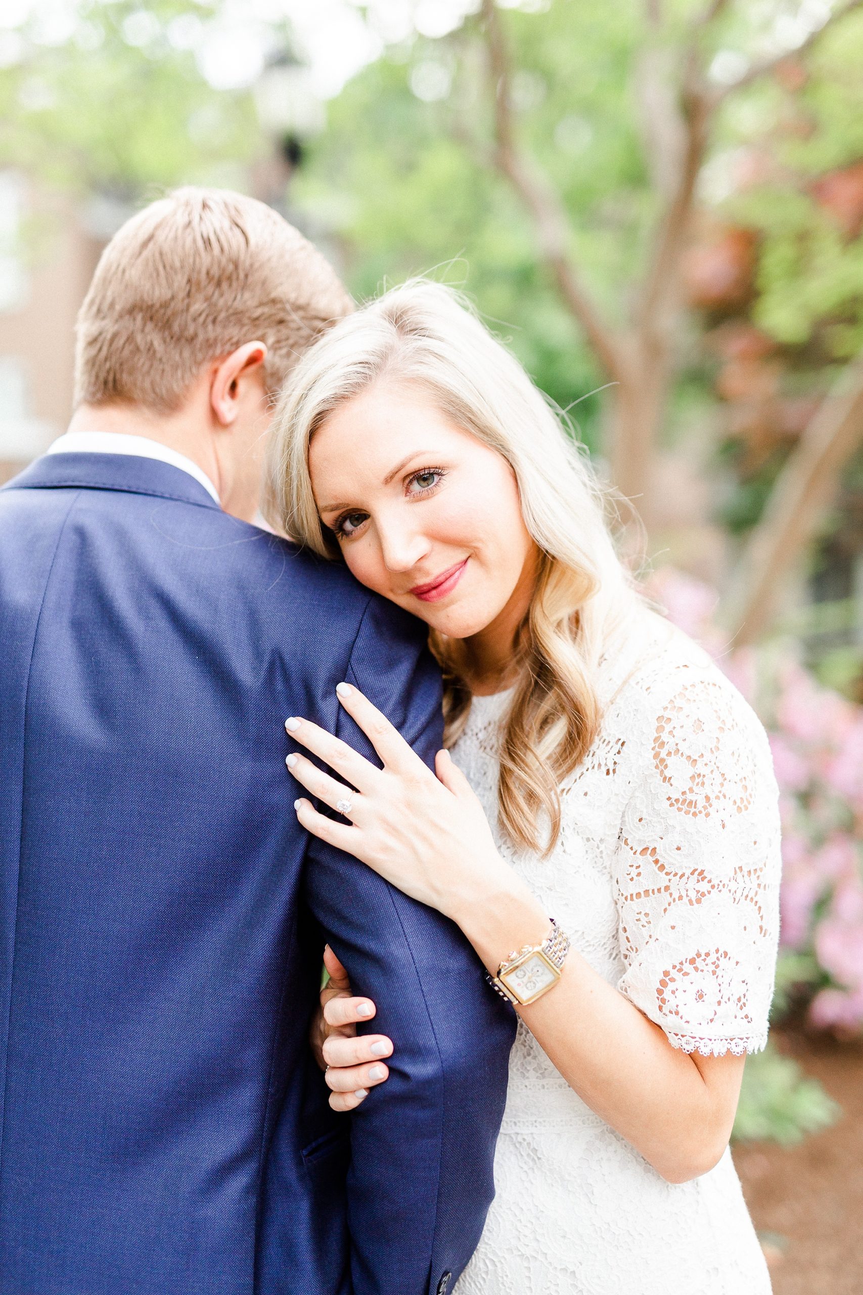 bride leans on groom's shoulder during engagement photos