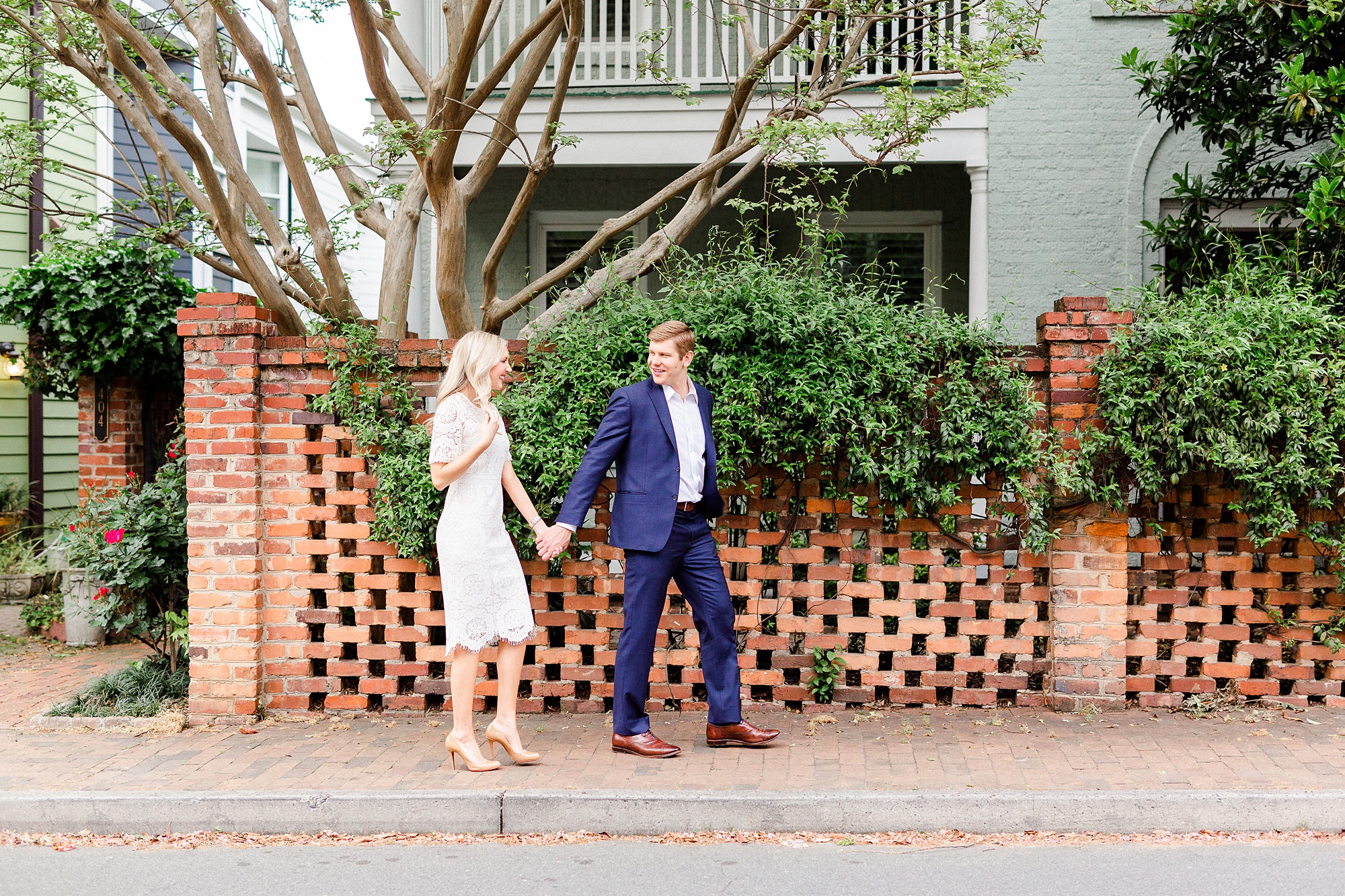 stylish Charlotte engagement photos on sidewalk