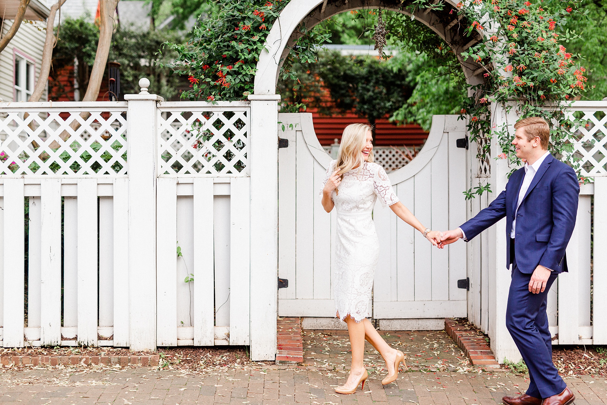 bride and groom walk along fence during Charlotte NC