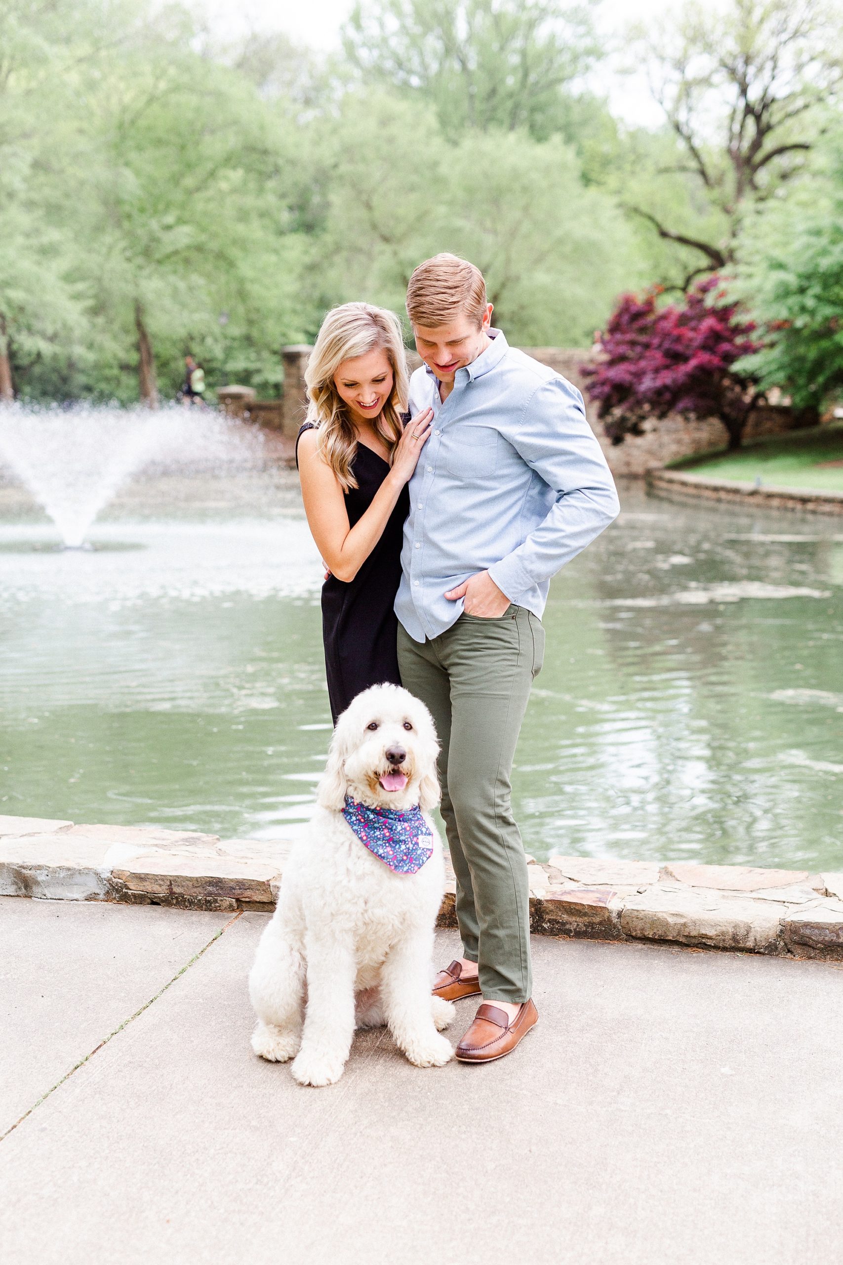 couple poses with dog during Freedom Park engagement session