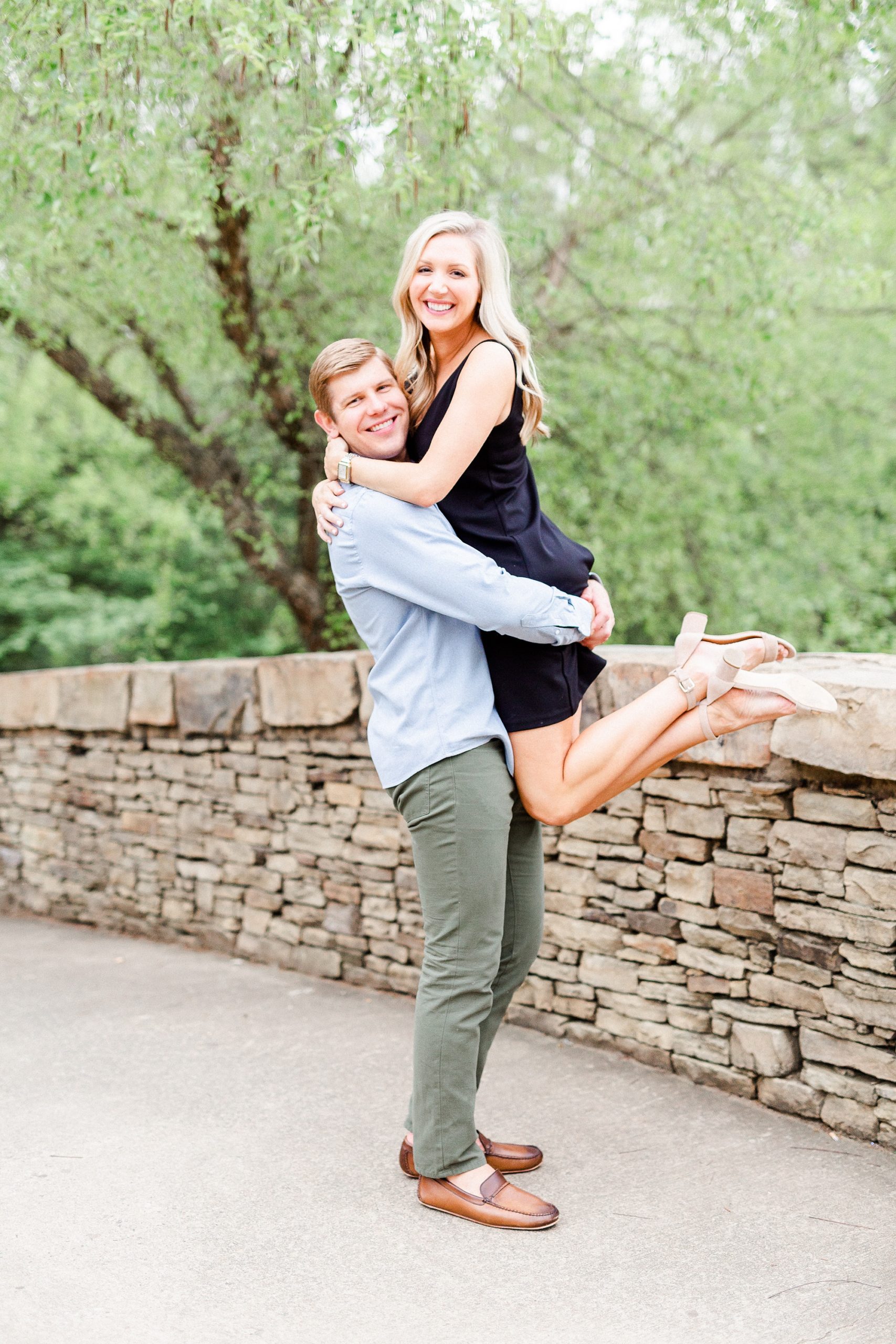 groom lifts bride during stylish Charlotte engagement photos