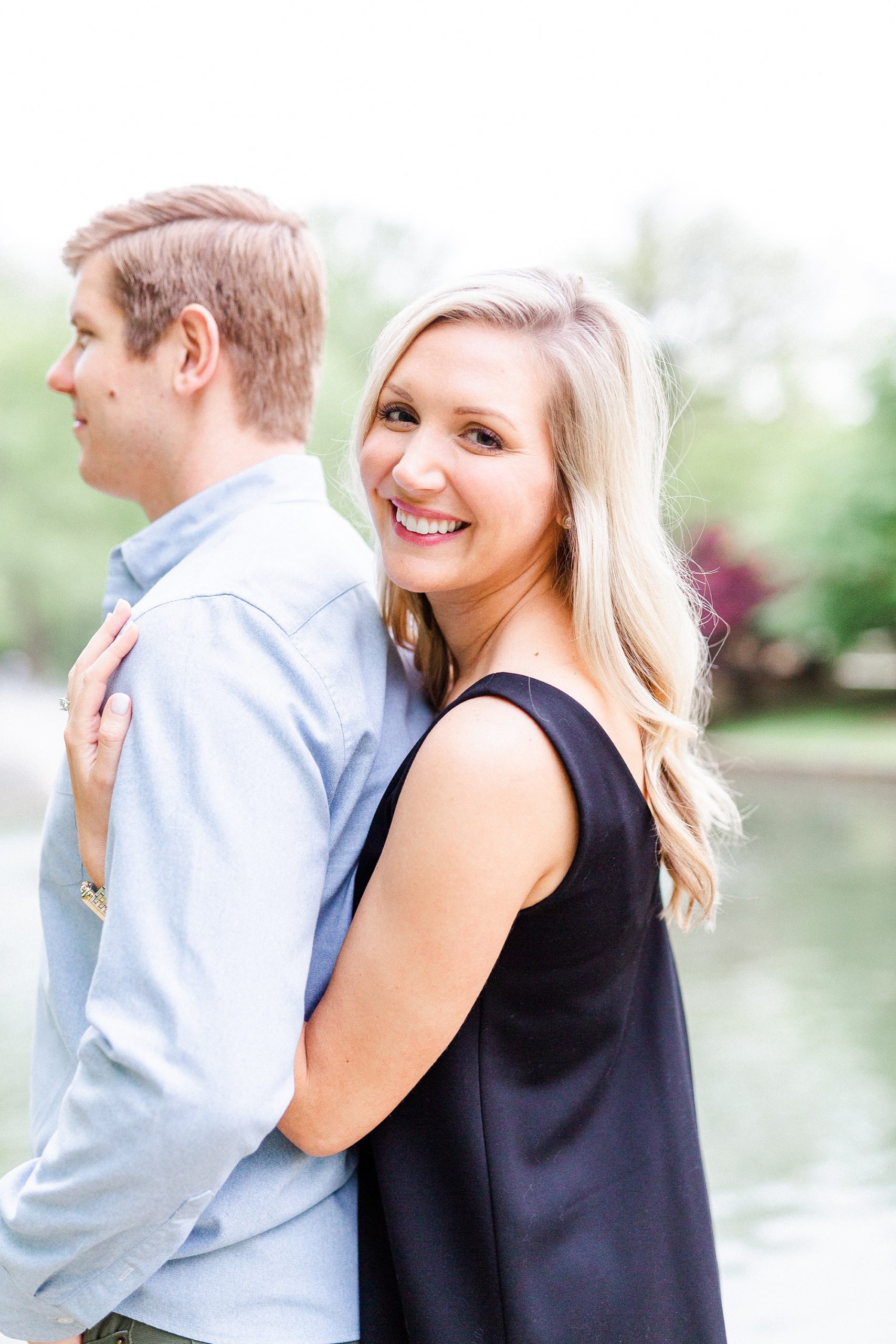 stylish Charlotte engagement photos with bride hugging groom