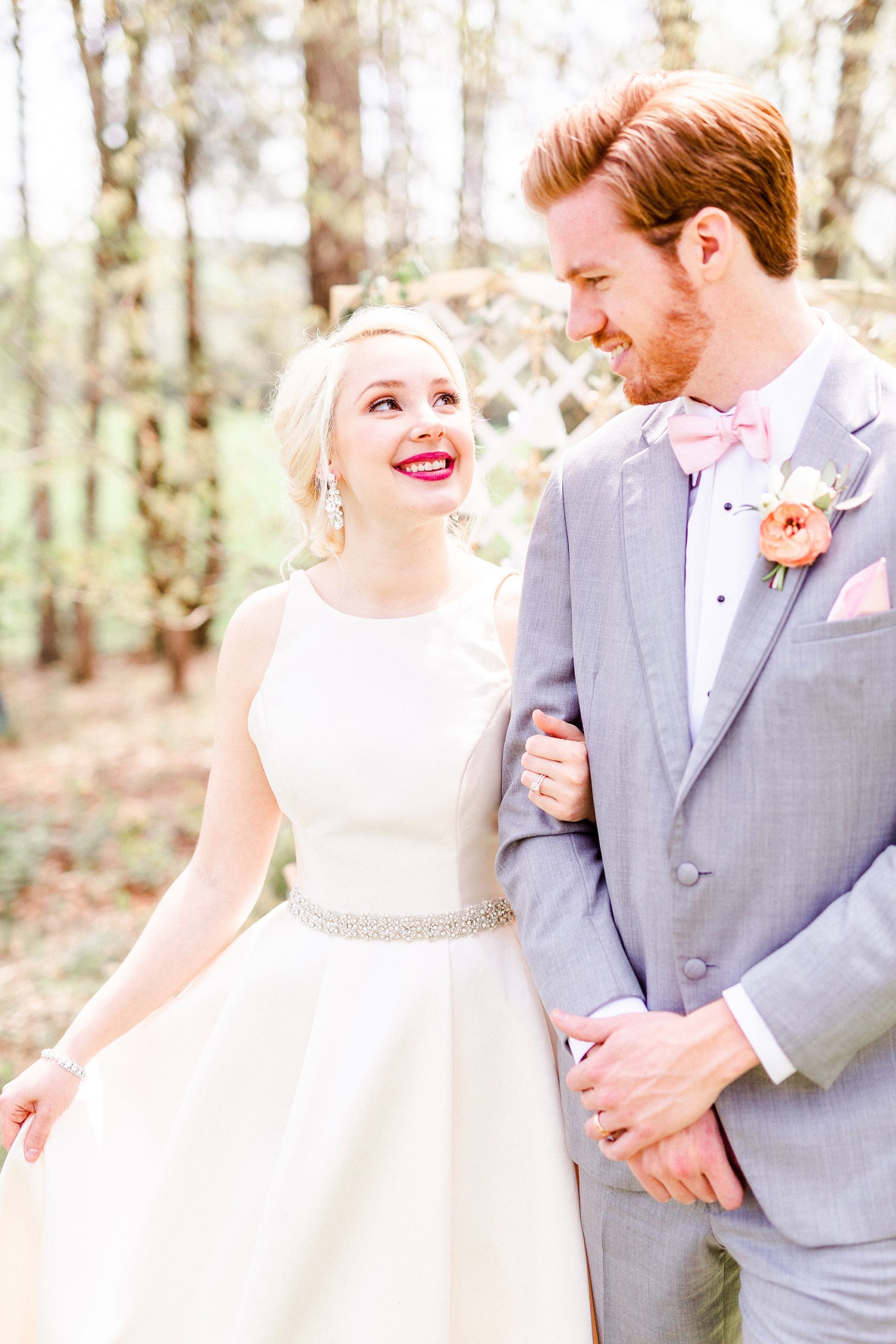 newlyweds walk through field at Carolina Country Weddings