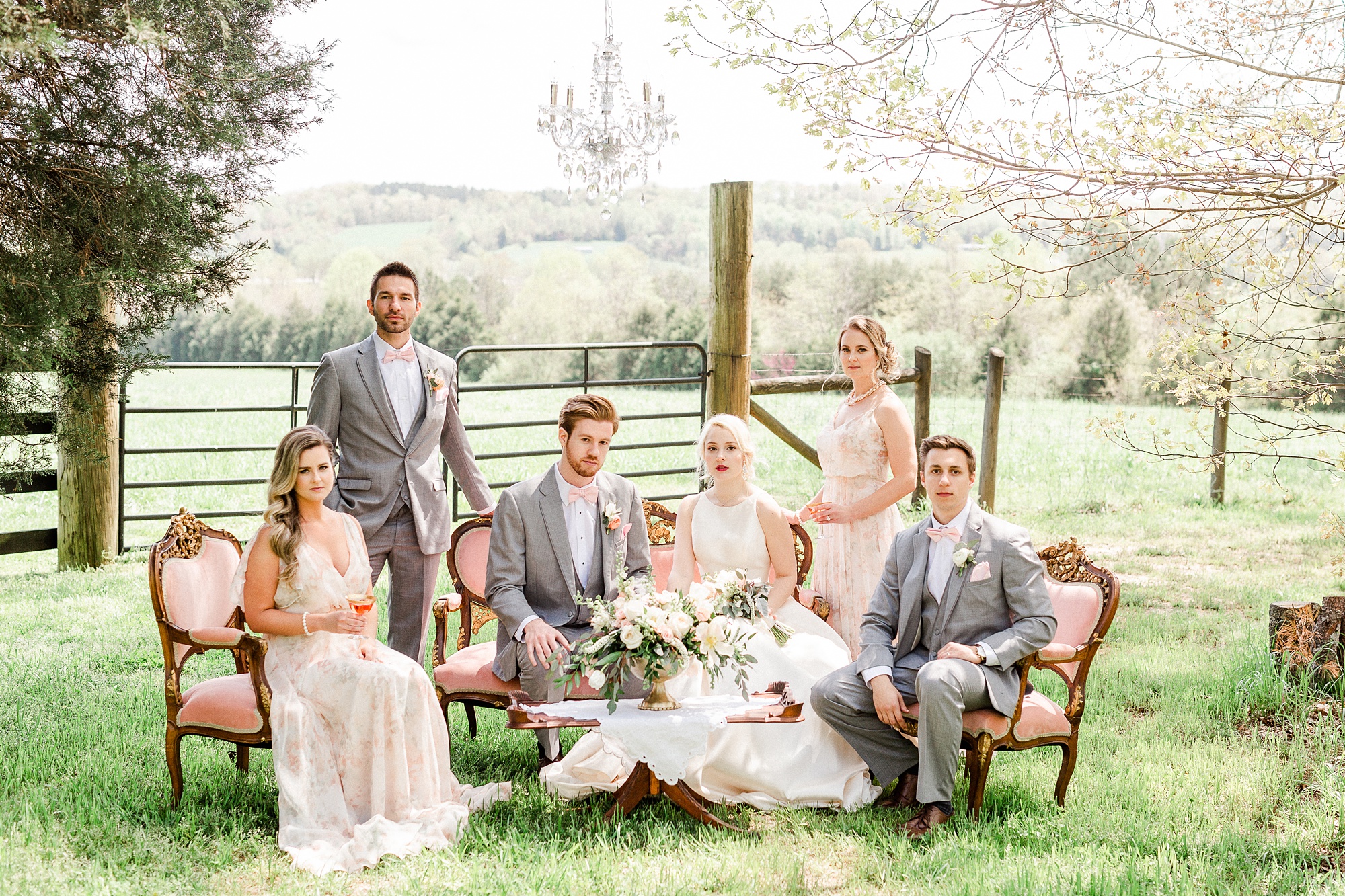 newlyweds pose with bridal party in pink and grey