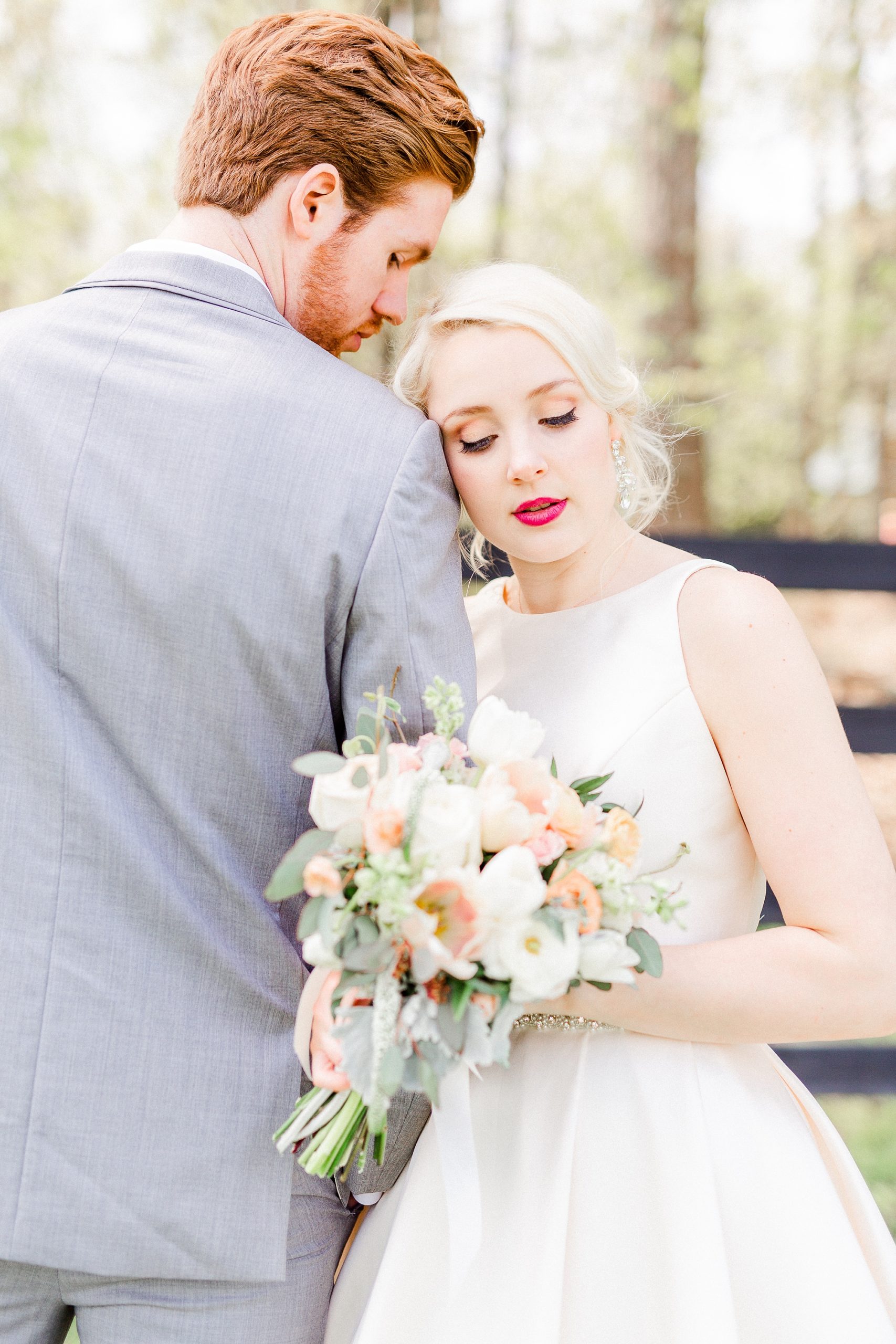 bride leans against groom's arm at Carolina Country Weddings
