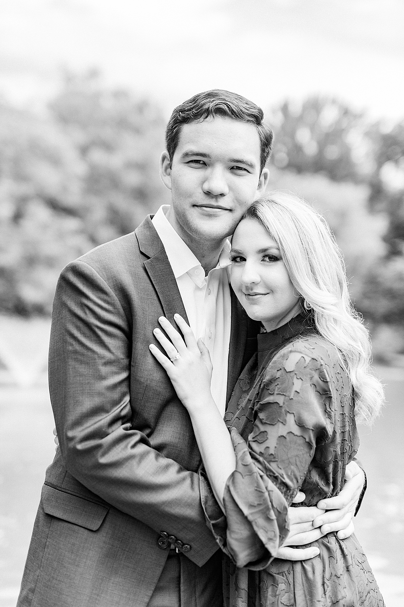 couple hugs in Freedom Park during uptown Charlotte engagement photos
