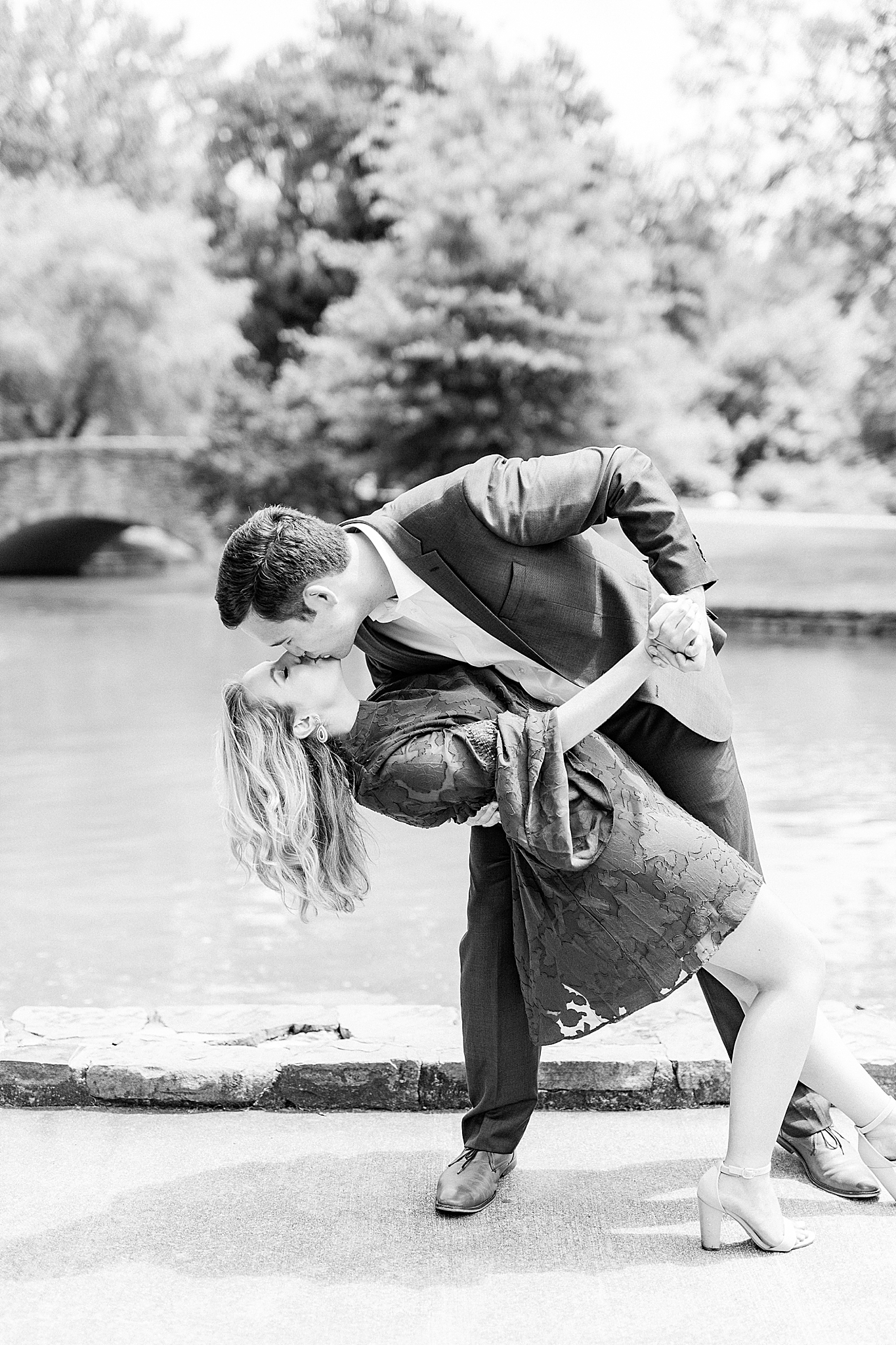 groom dips bride during uptown Charlotte engagement photos