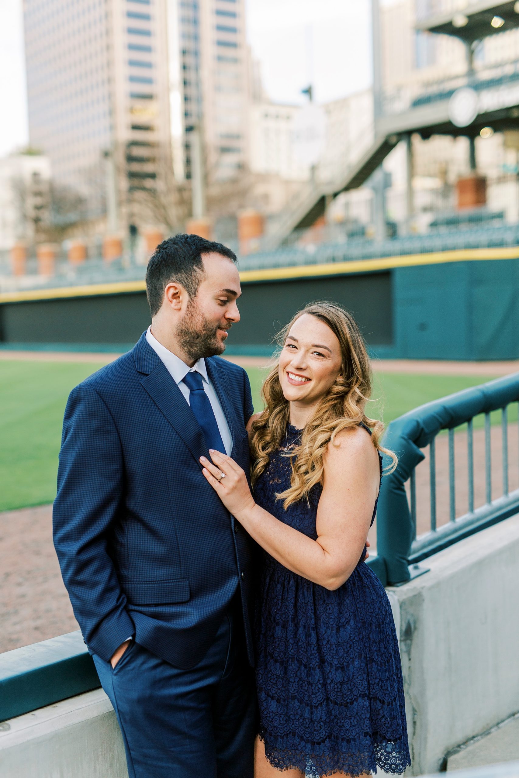 bride and groom pose along Charlotte Knights field