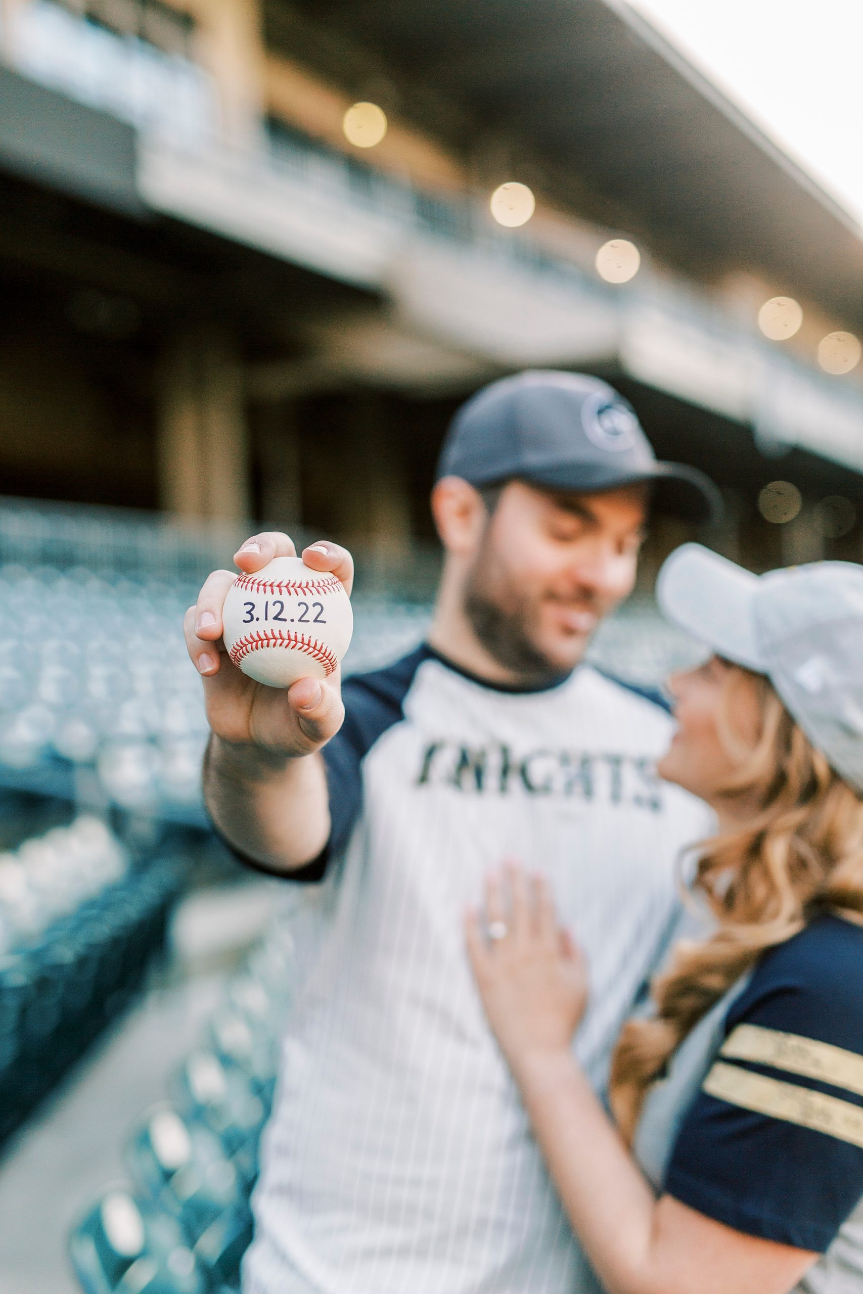 groom holds baseball with save the date