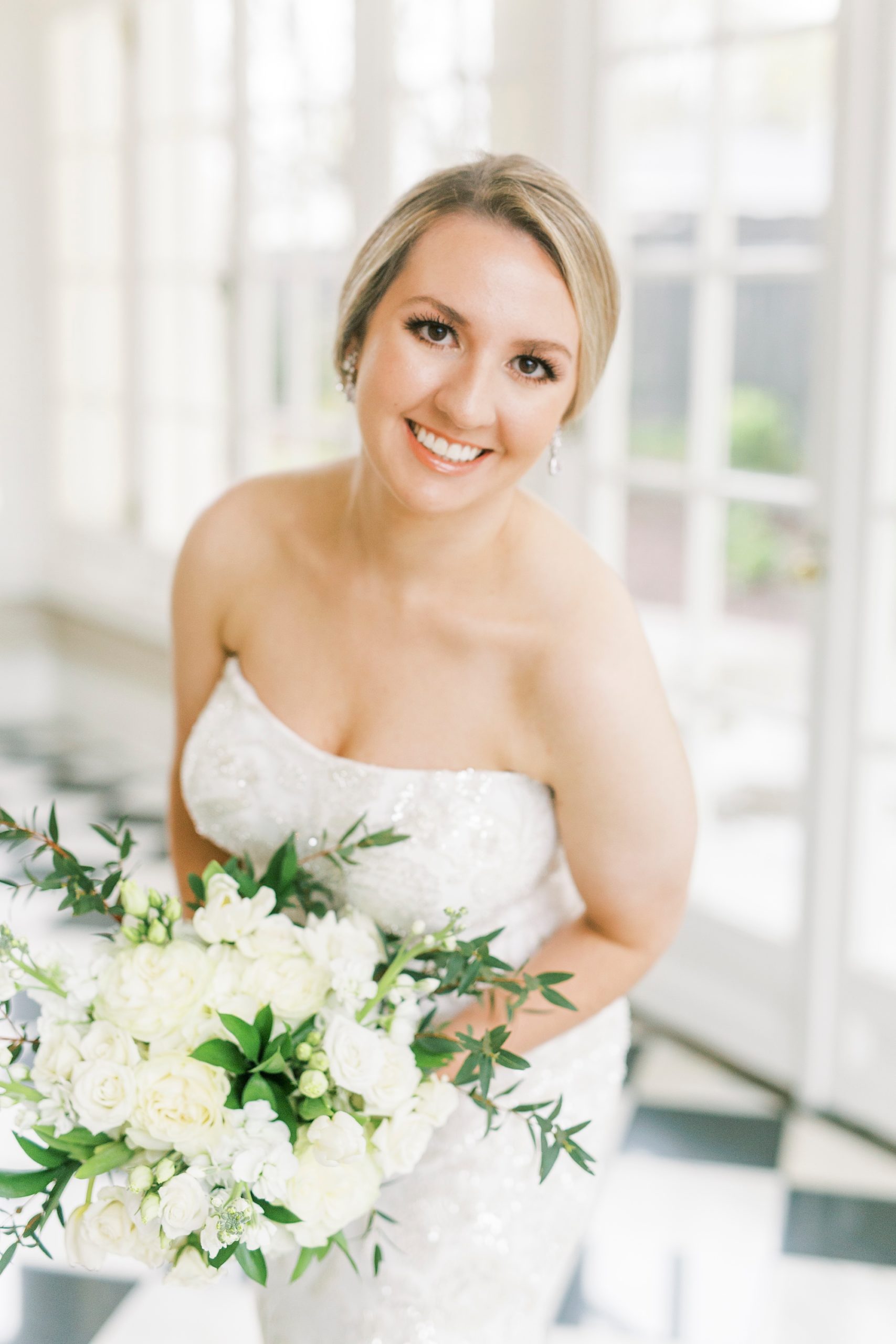 bride smiles and leans forward during bridal portraits in Charlotte NC