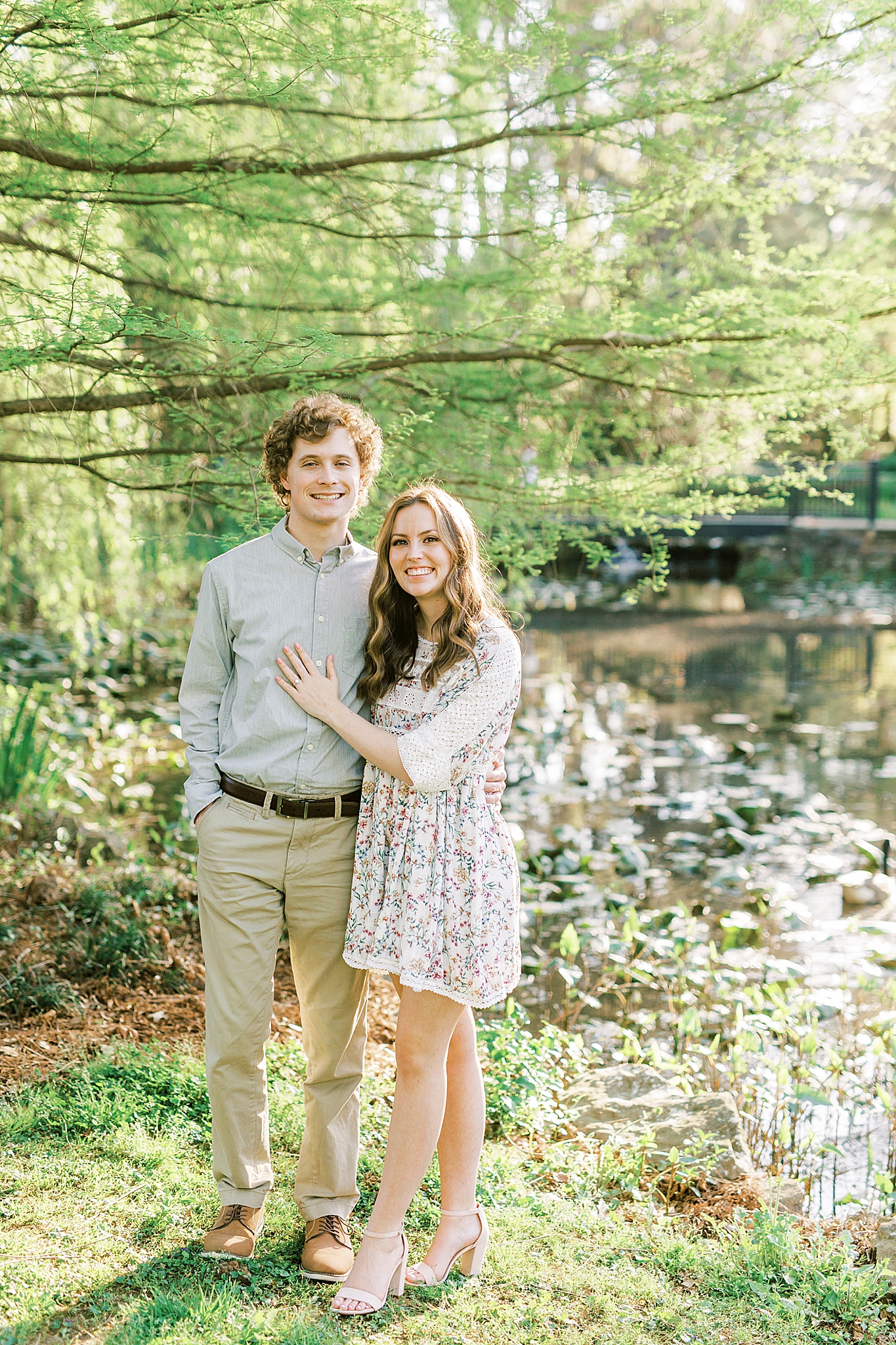 bride and groom pose by lake in Glencairn Gardens