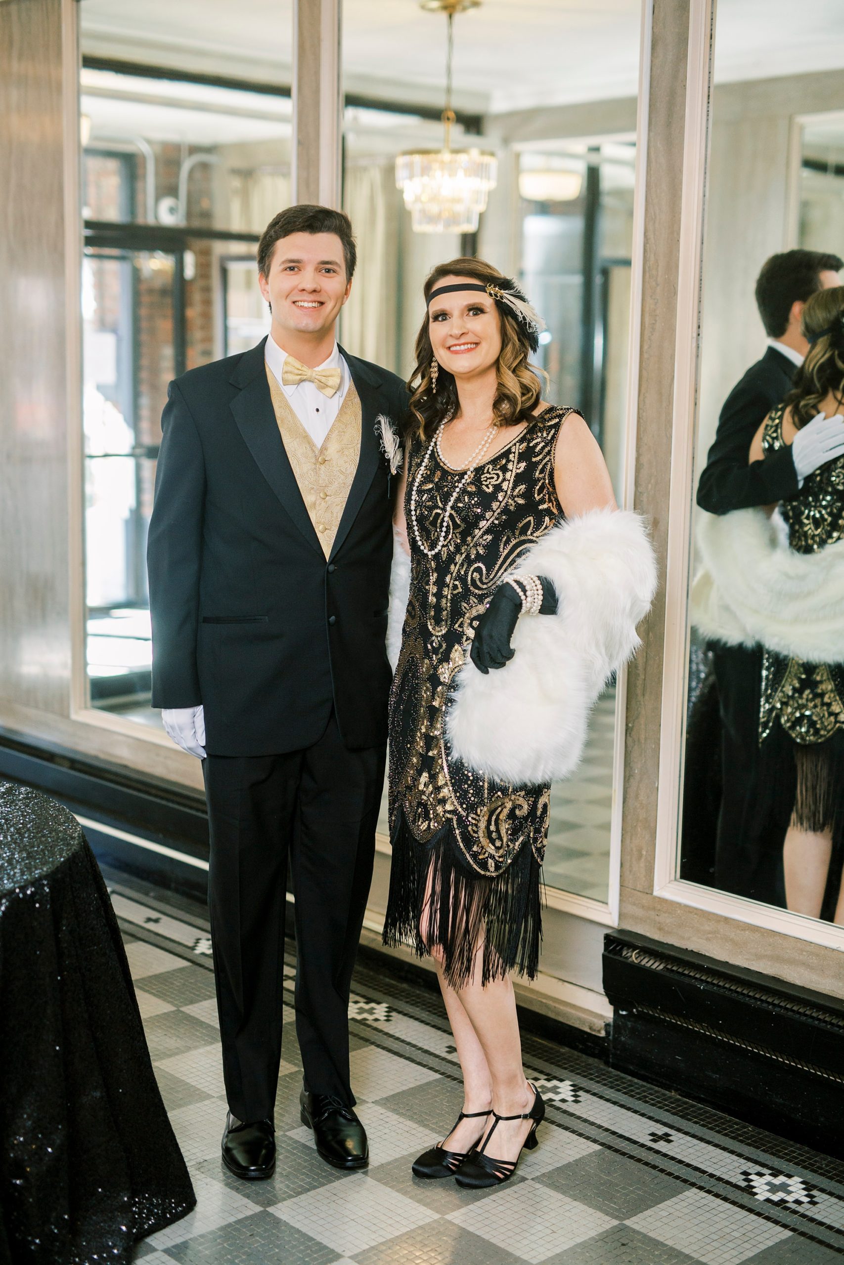 mom poses with son during Great Gatsby birthday party at The Hotel Concord