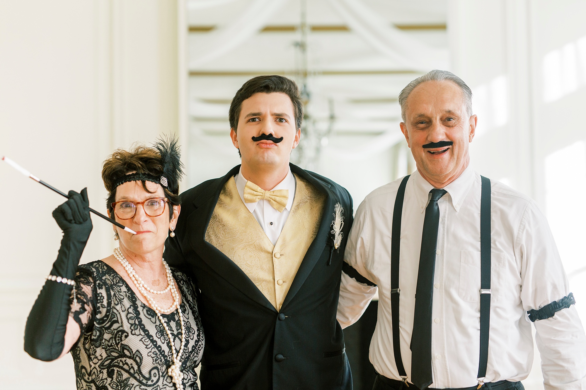 guest of honor poses with grandparents during Great Gatsby birthday party