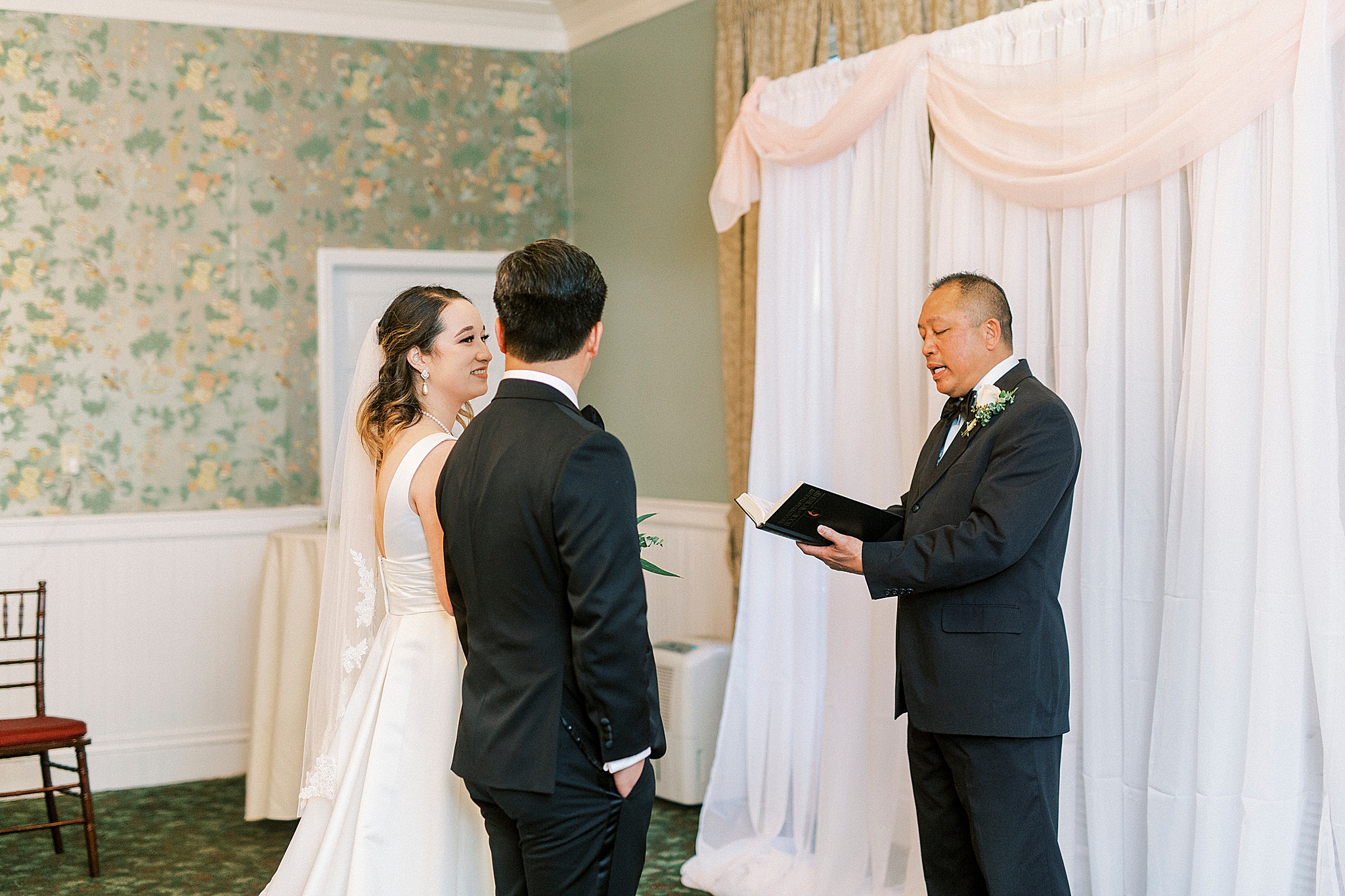 bride and groom listen to officiant during NC wedding