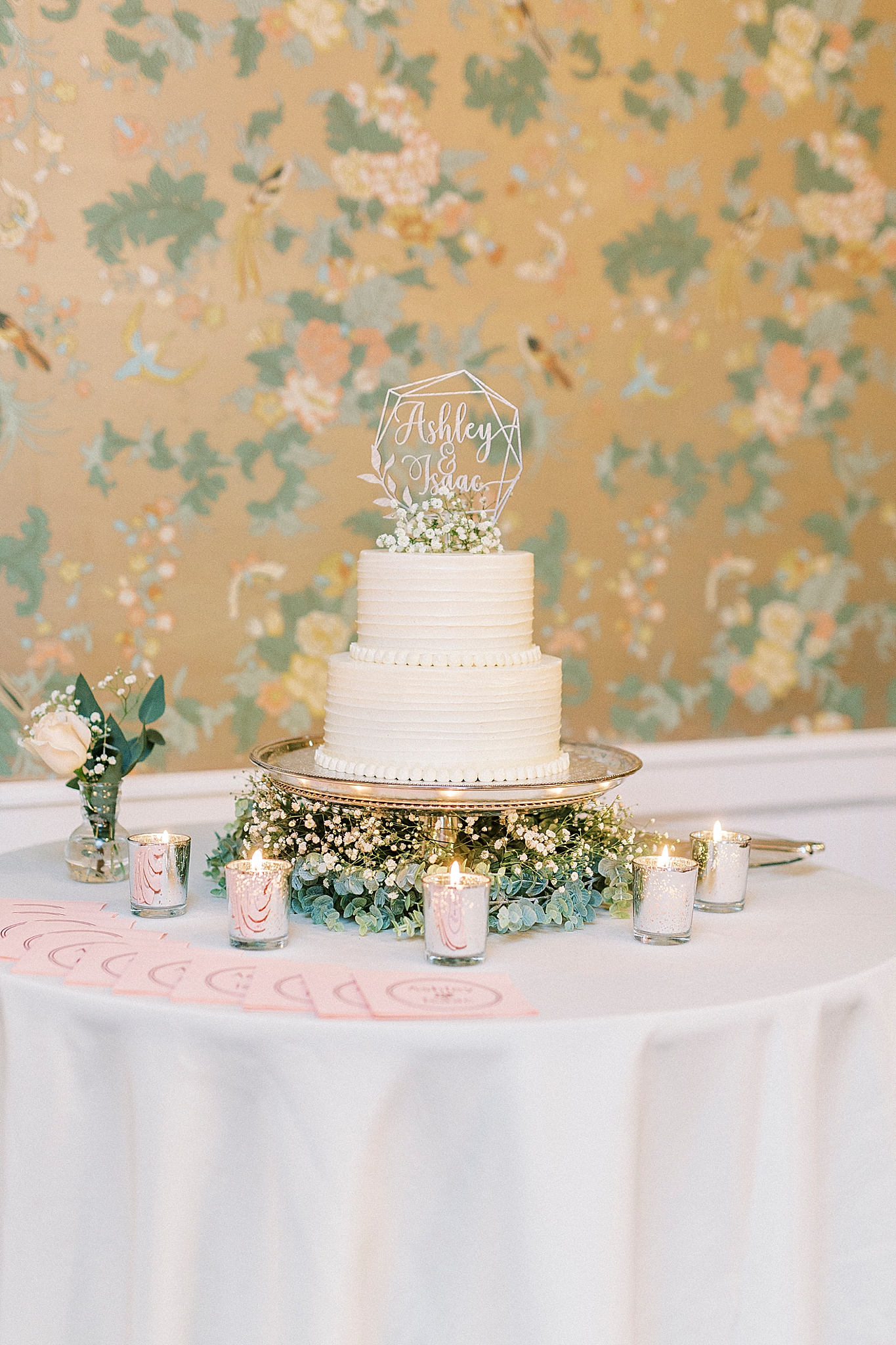 two-tiered wedding cake with topper
