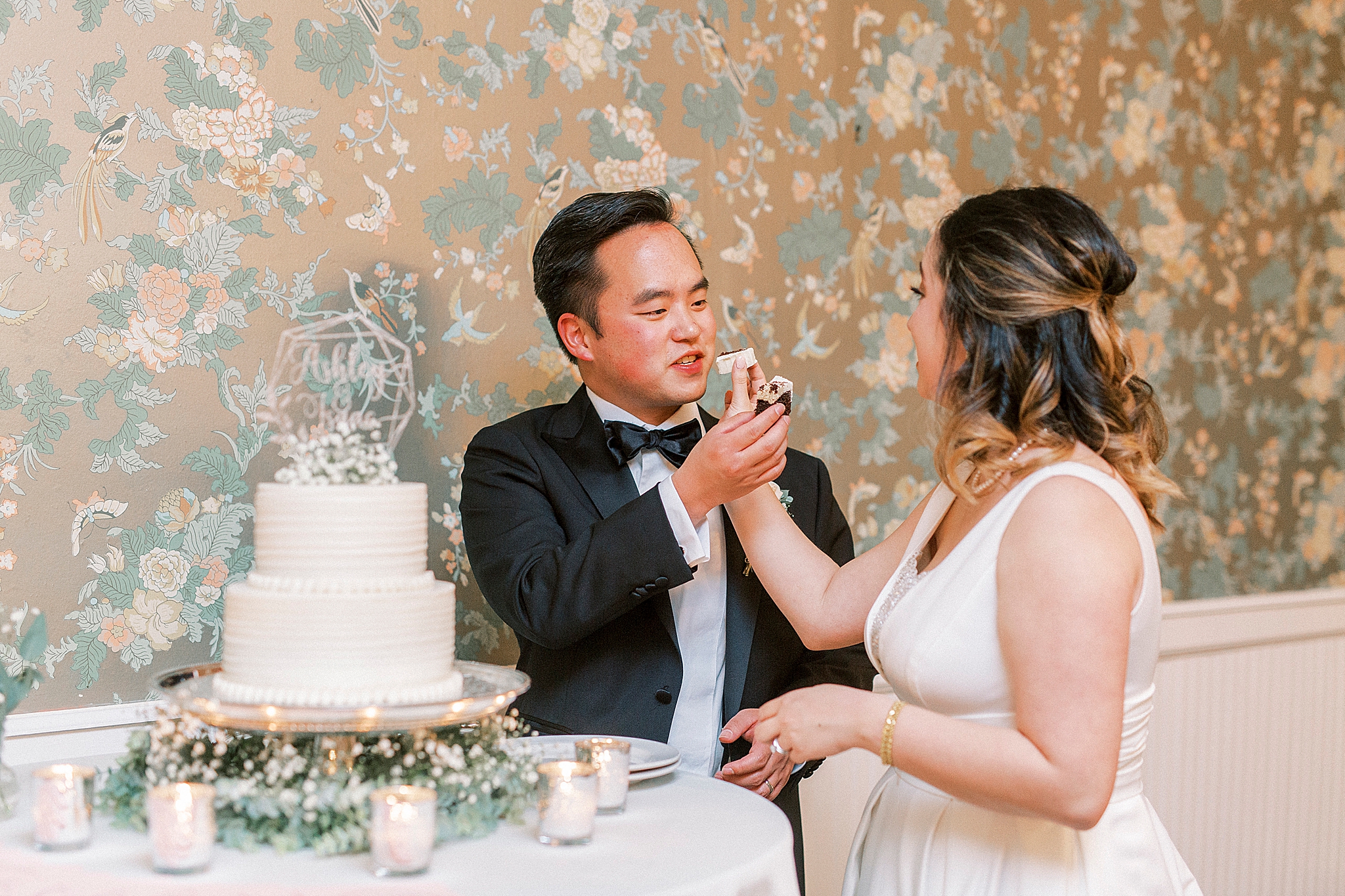 newlyweds feed each other cake