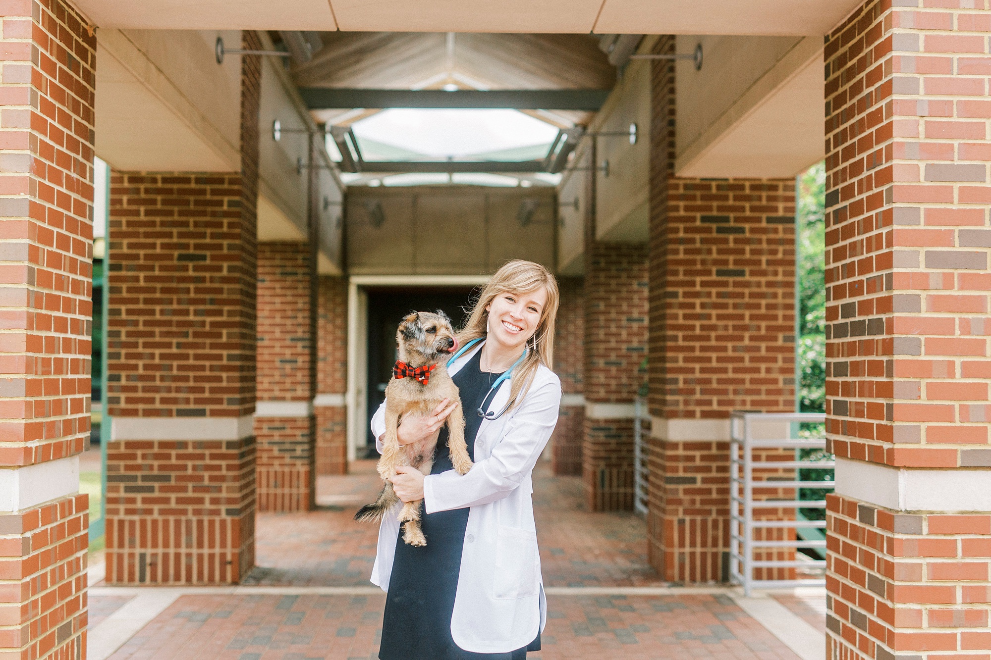 senior and her dog pose outside NC State Vet School