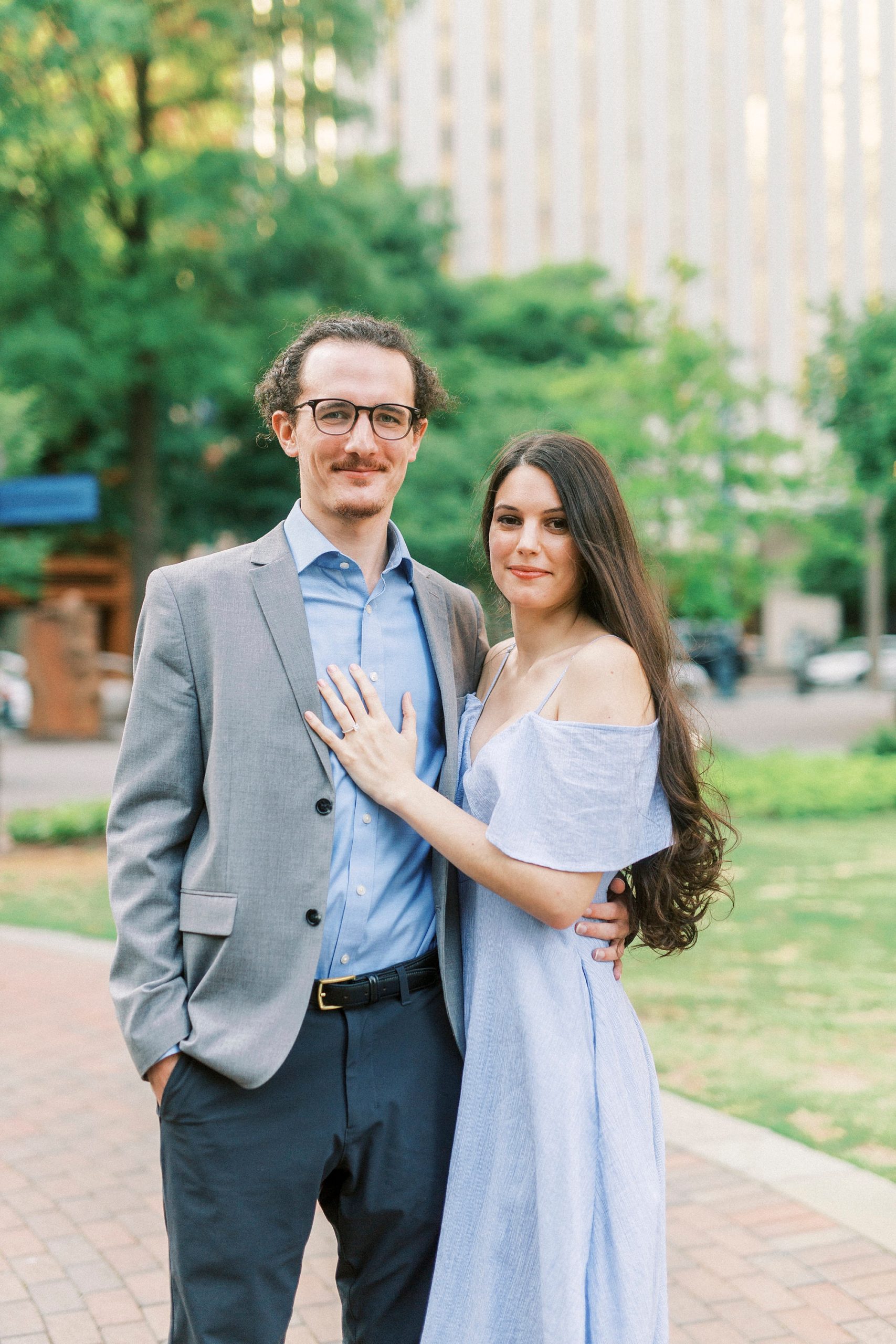 couple poses in The Green Charlotte in Uptown Charlotte