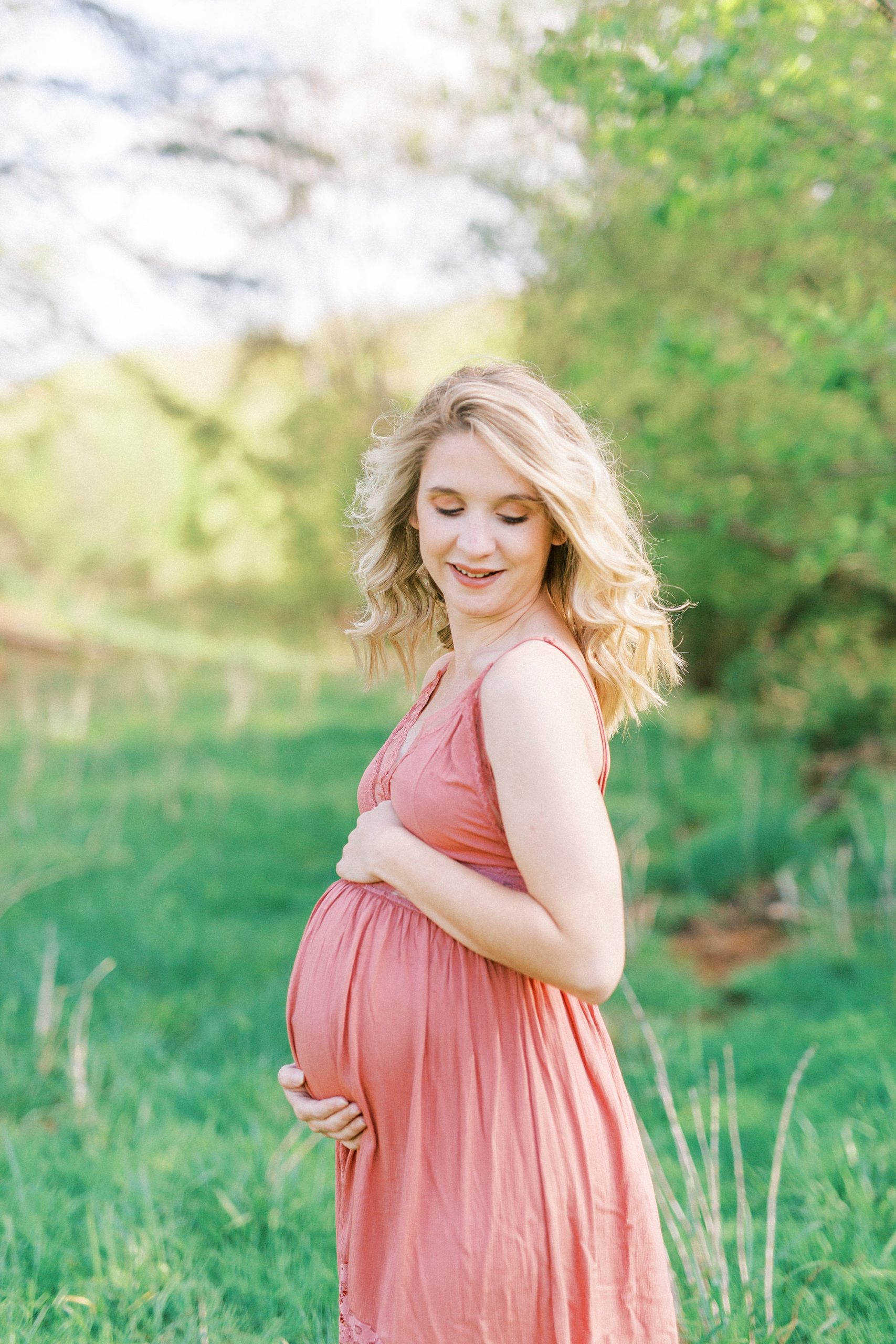 expecting mother looks over should during Winston-Salem maternity photos