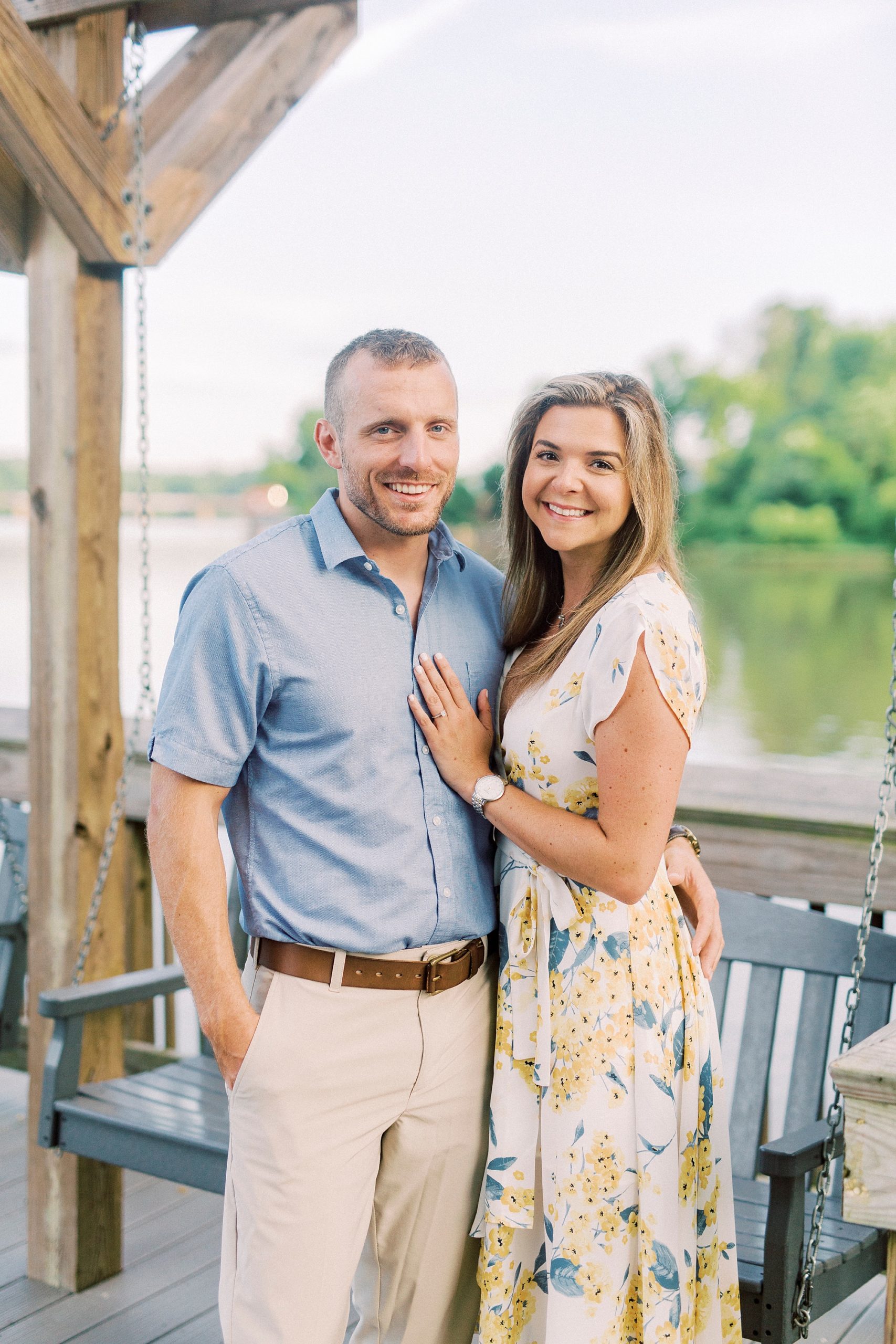 bride and groom stand together in front of Catawba River