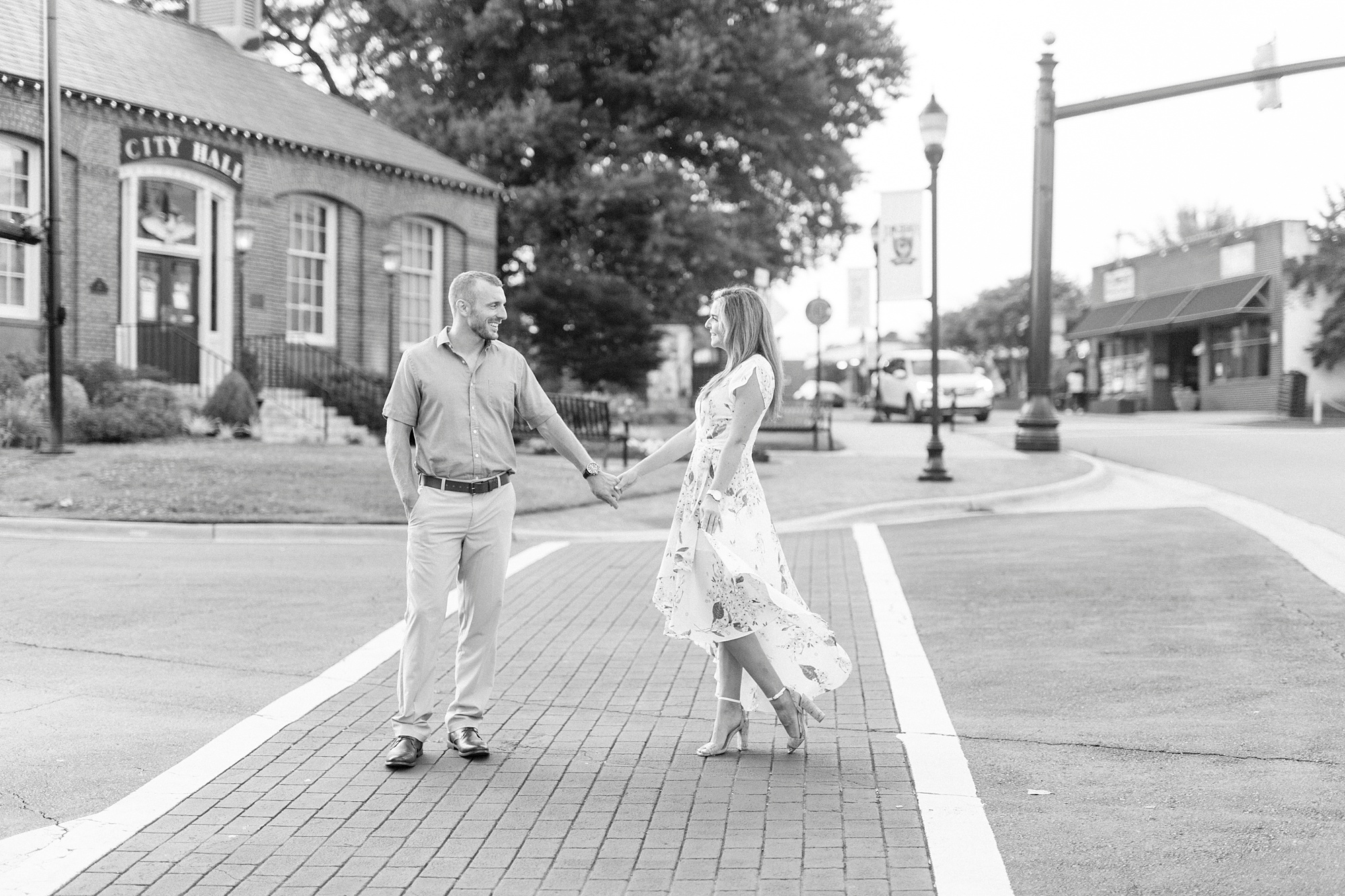 bride and groom walk through cross walk in Downtown Belmont