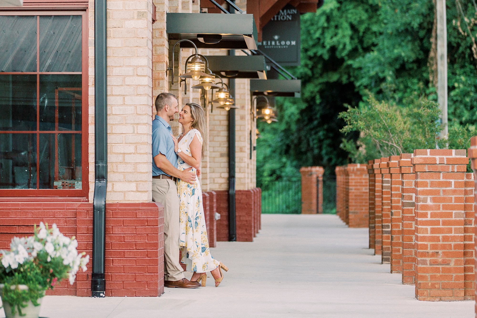 bride and groom lean against restaurant in Downtown Belmont