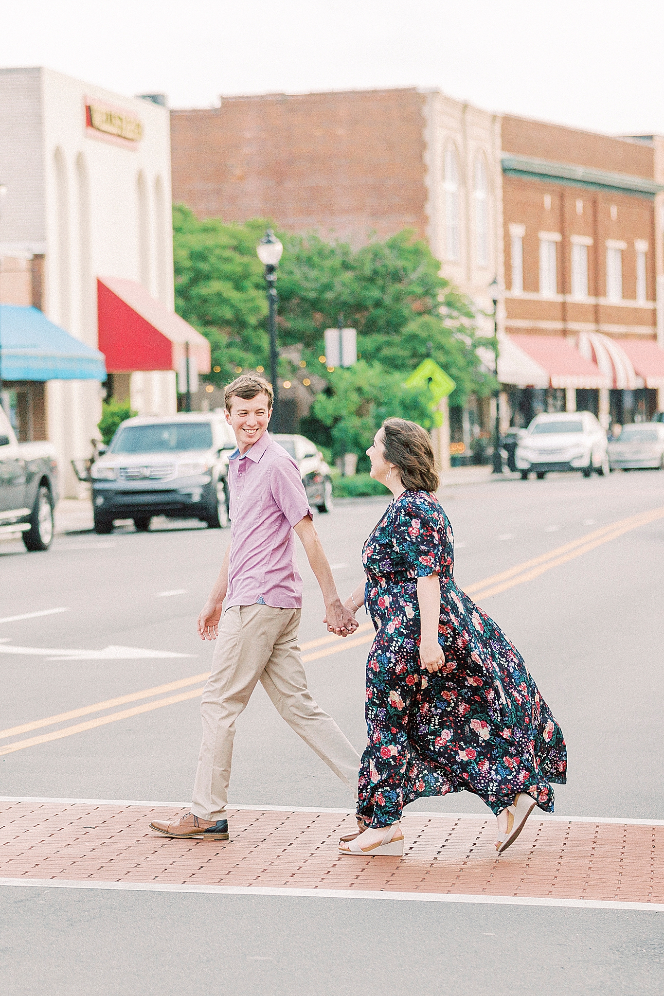 couple walks across street in Mooresville NC