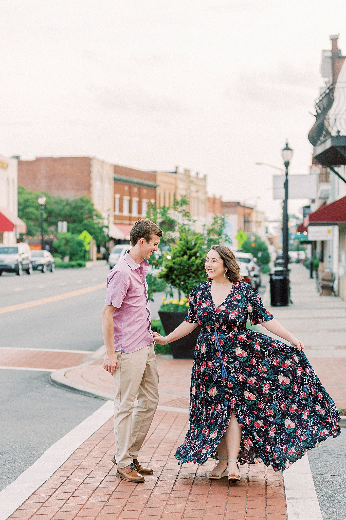 husband and wife dance in crosswalk of Downtown Mooresville