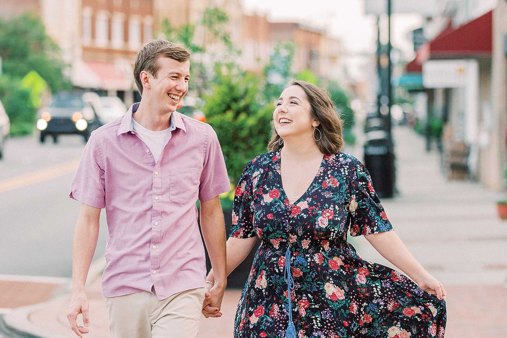 couple laughs together in Downtown Mooresville
